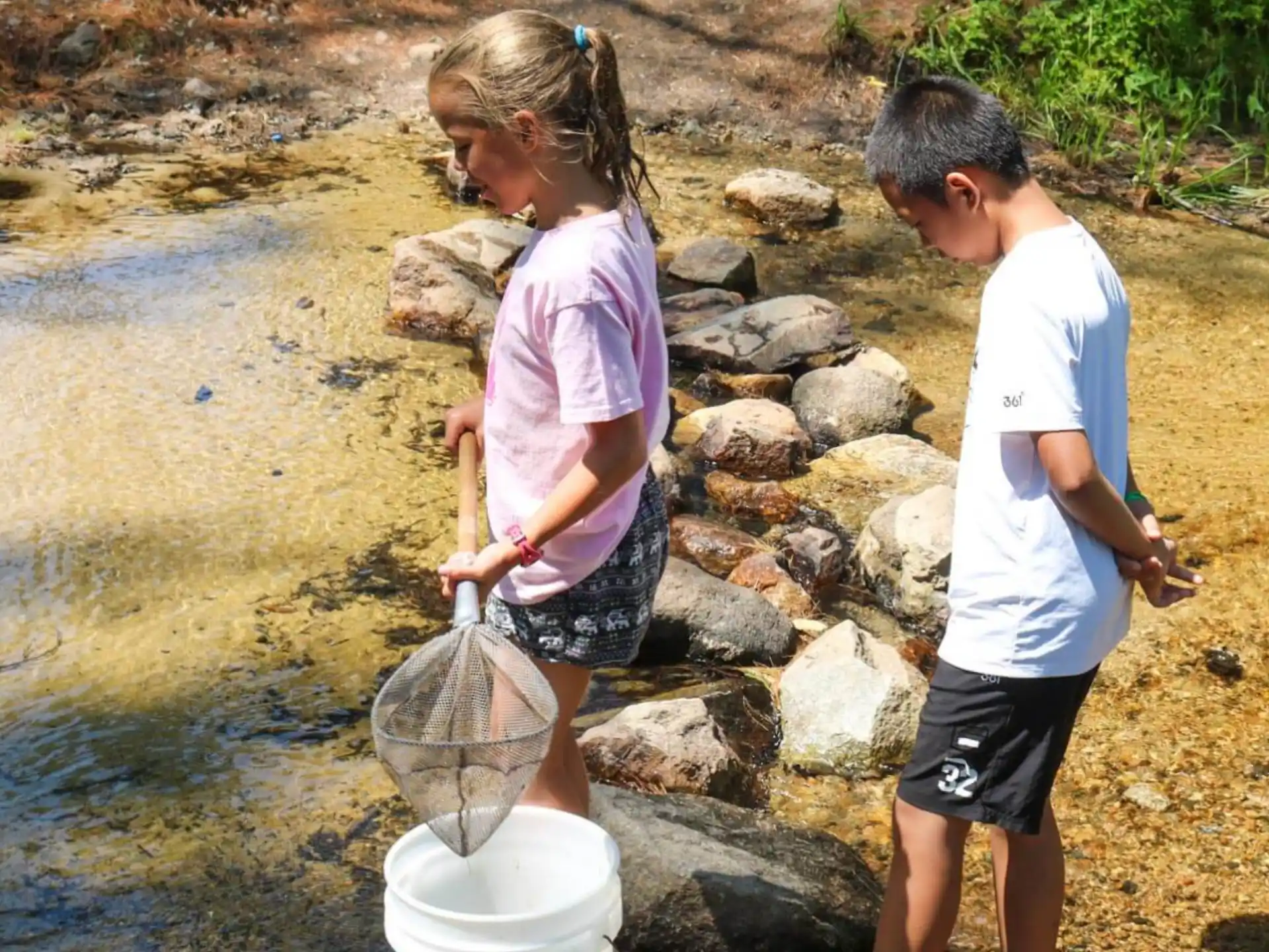 a couple of children fetching water