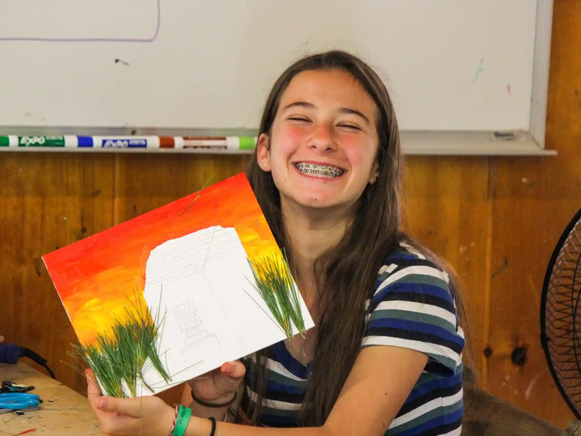 a girl holding a yellow and red paper