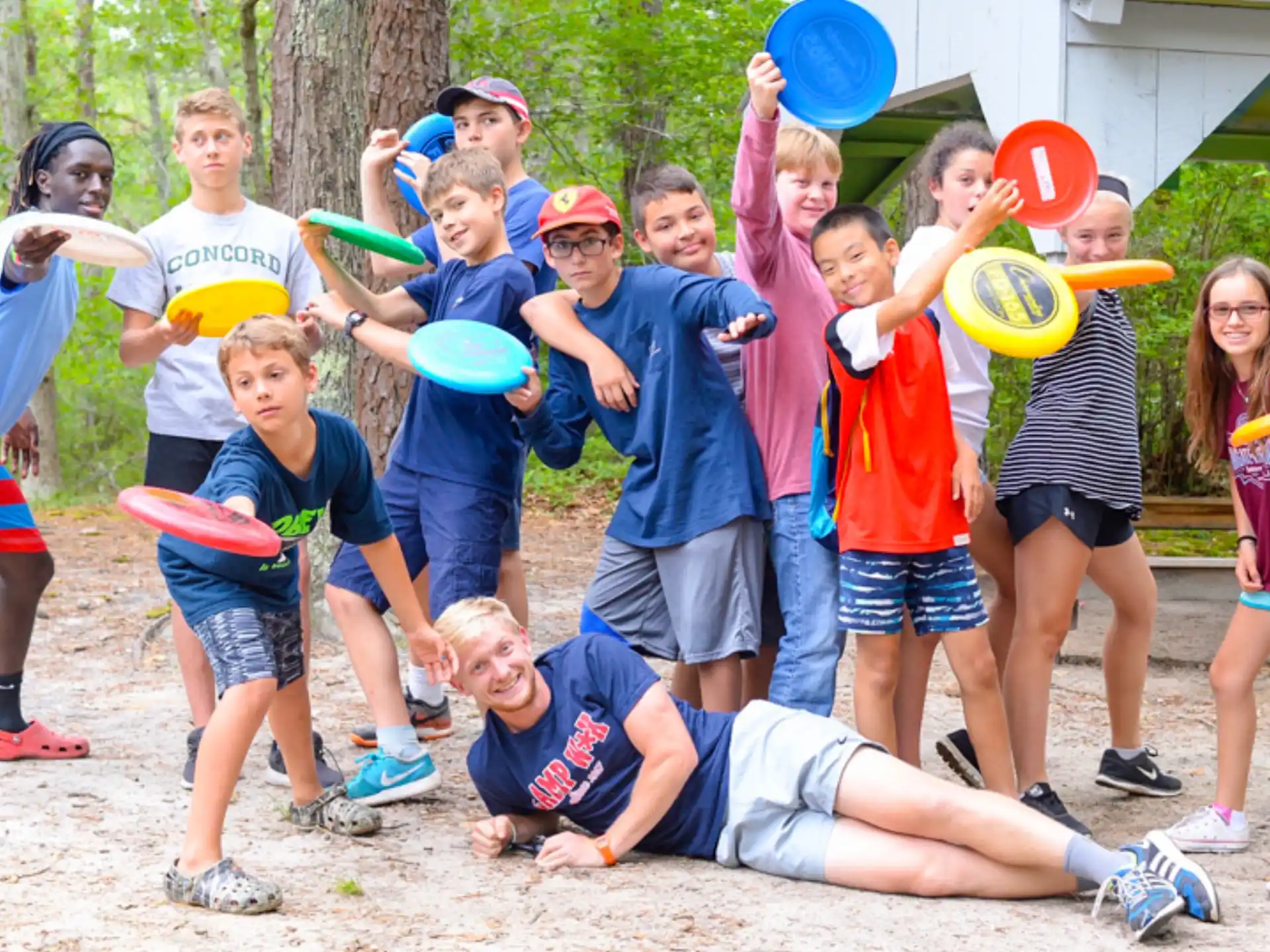 a group of kids holding frisbees
