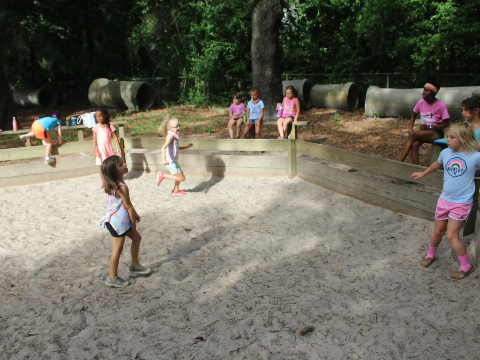 a group of children playing in sand