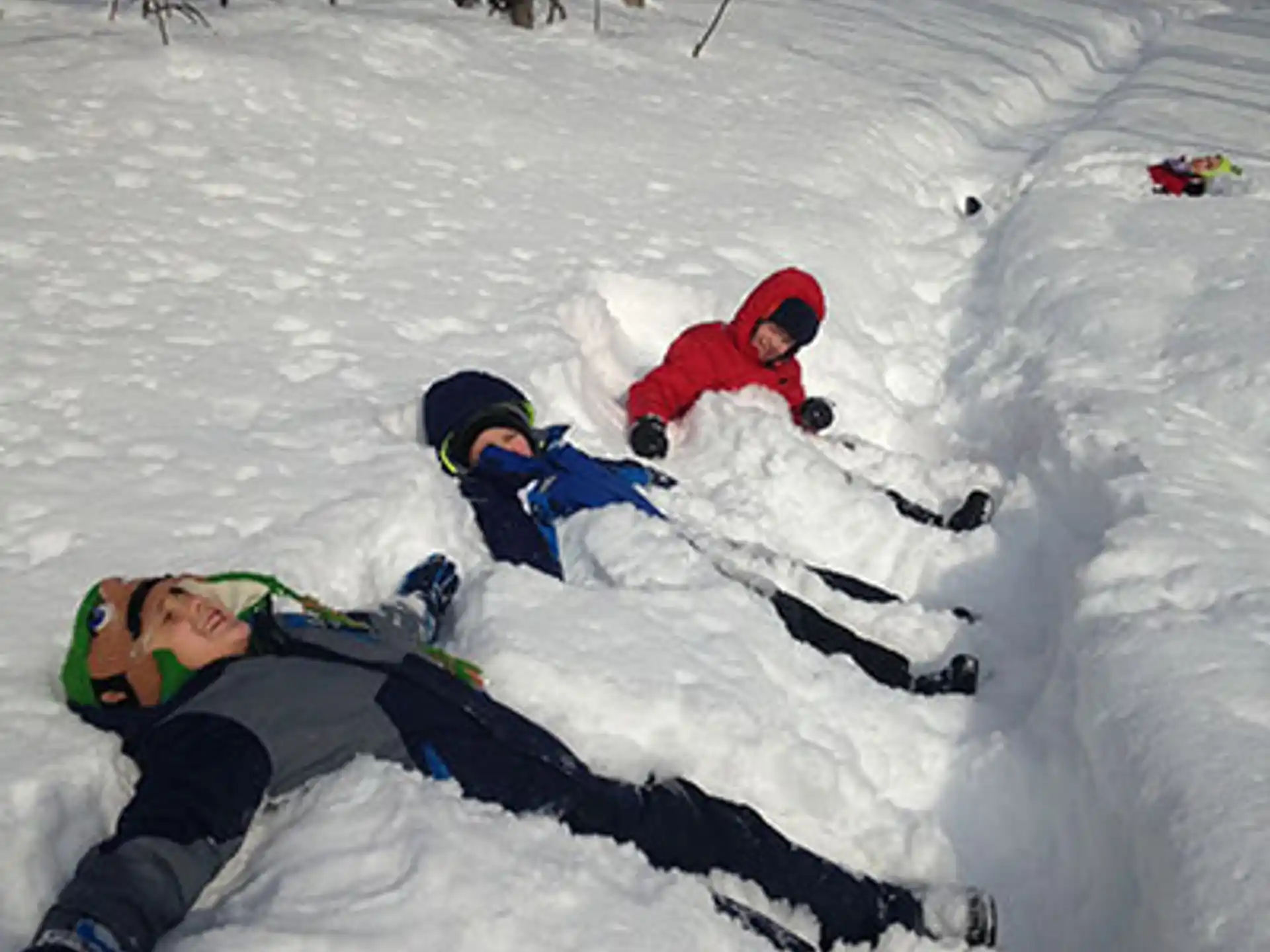 a group of kids playing in the snow