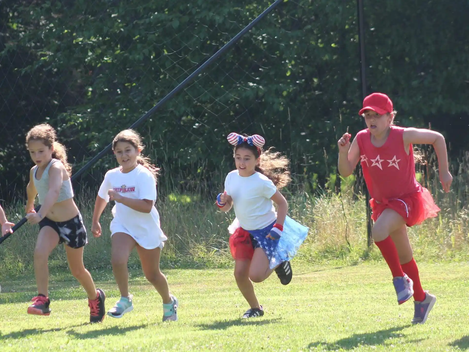 a group of girls running on a field