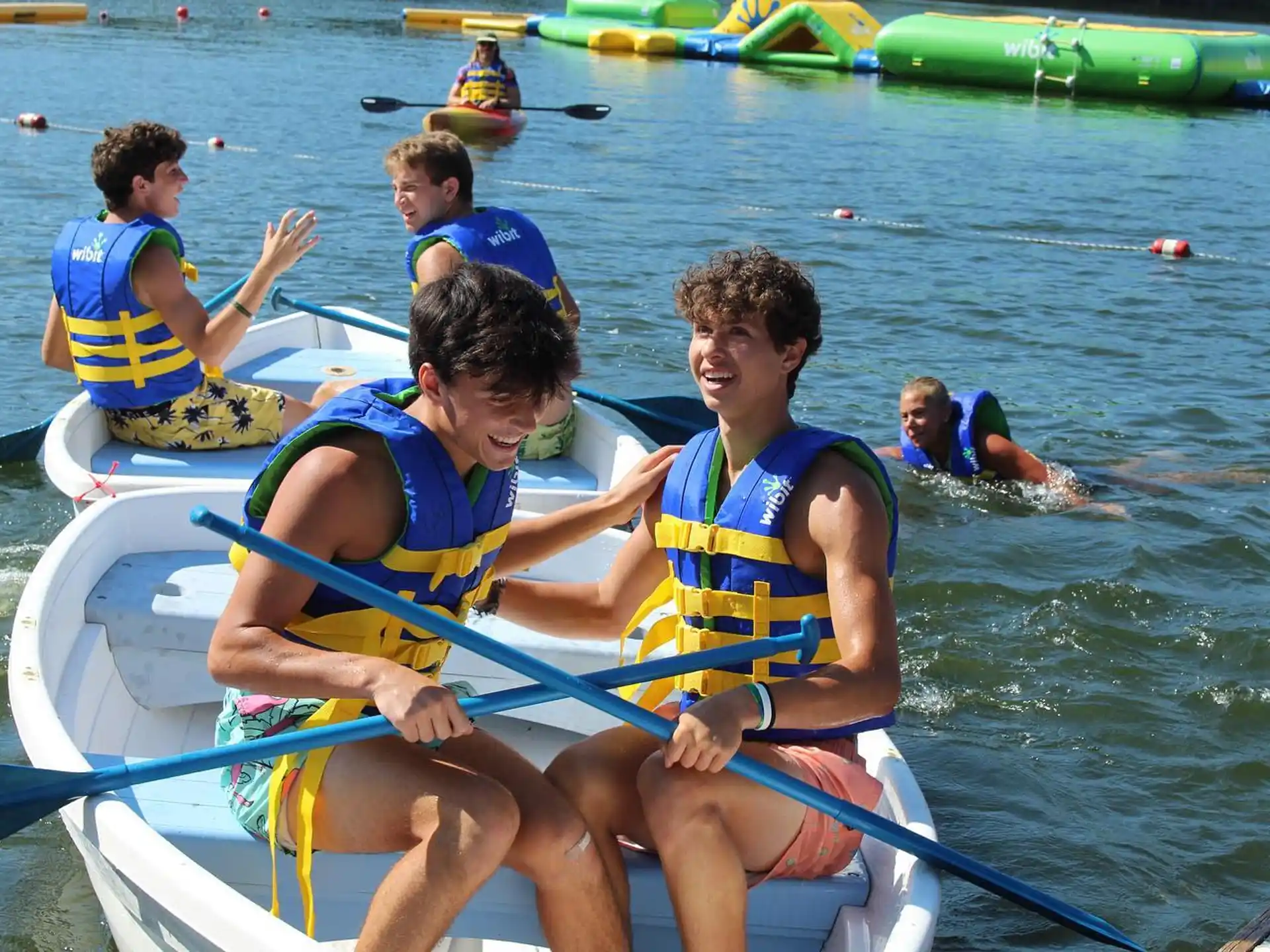 a group of people rowing a boat