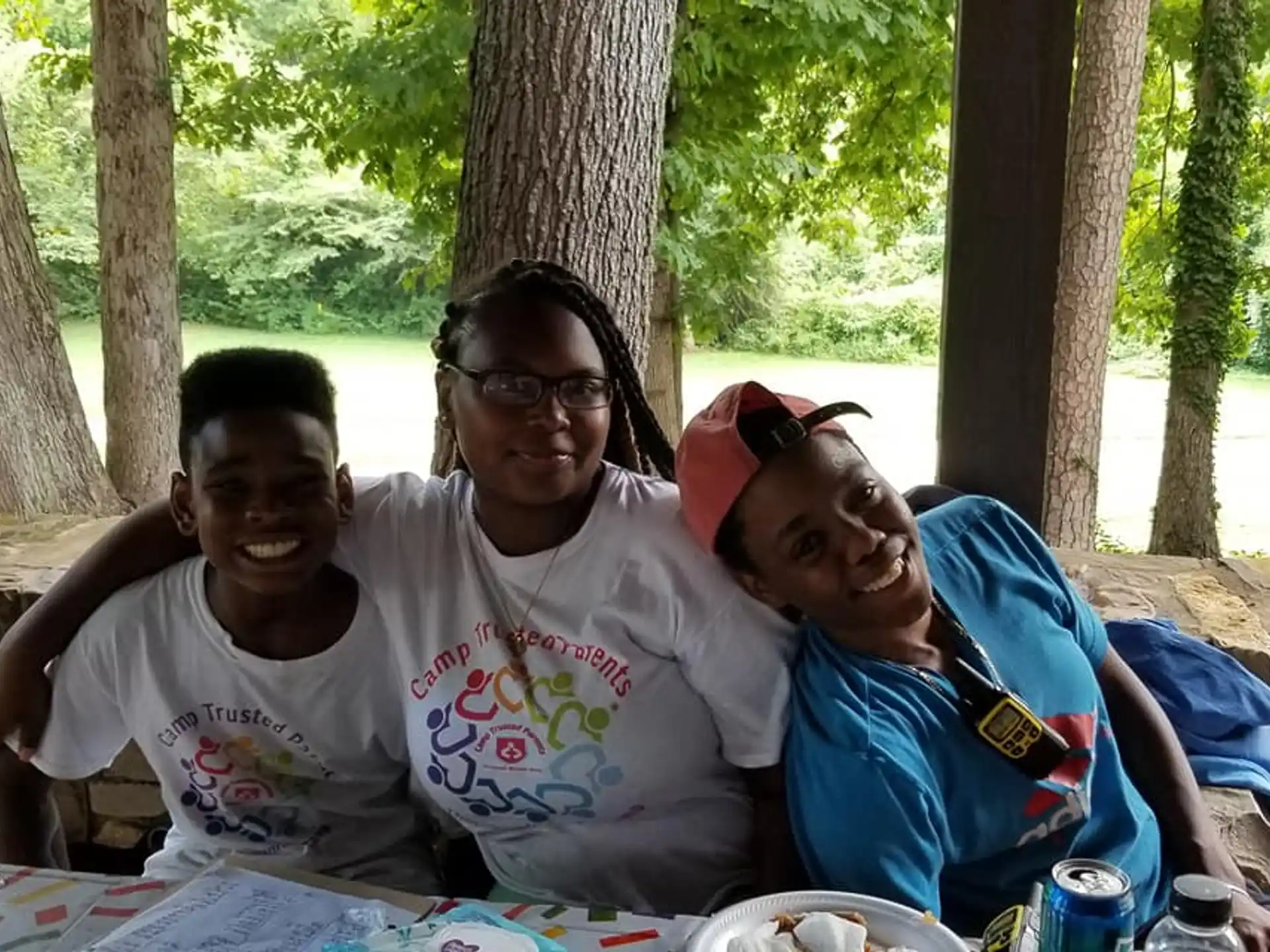 a group of people sitting at a table outside