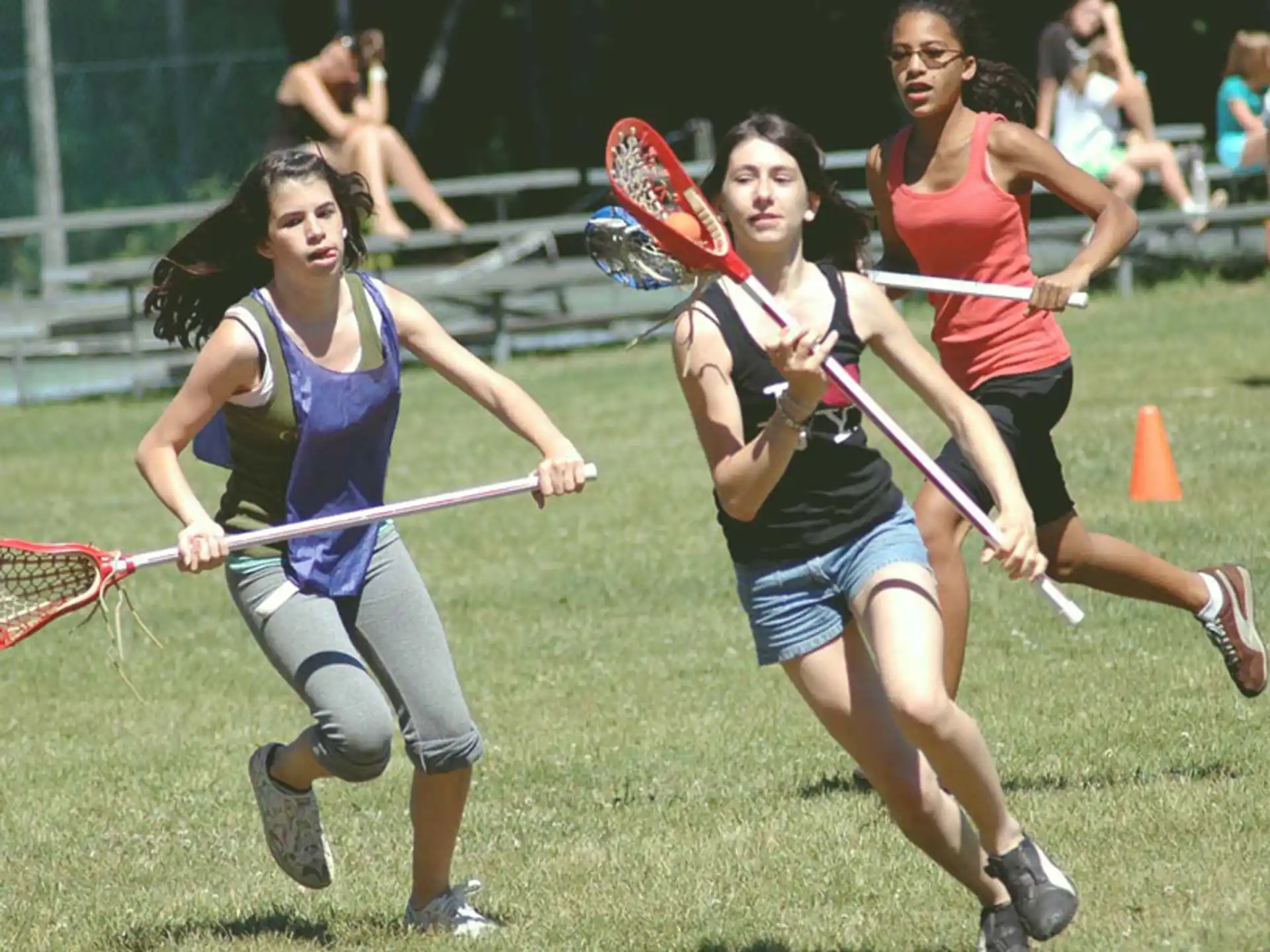 a group of women playing field hockey