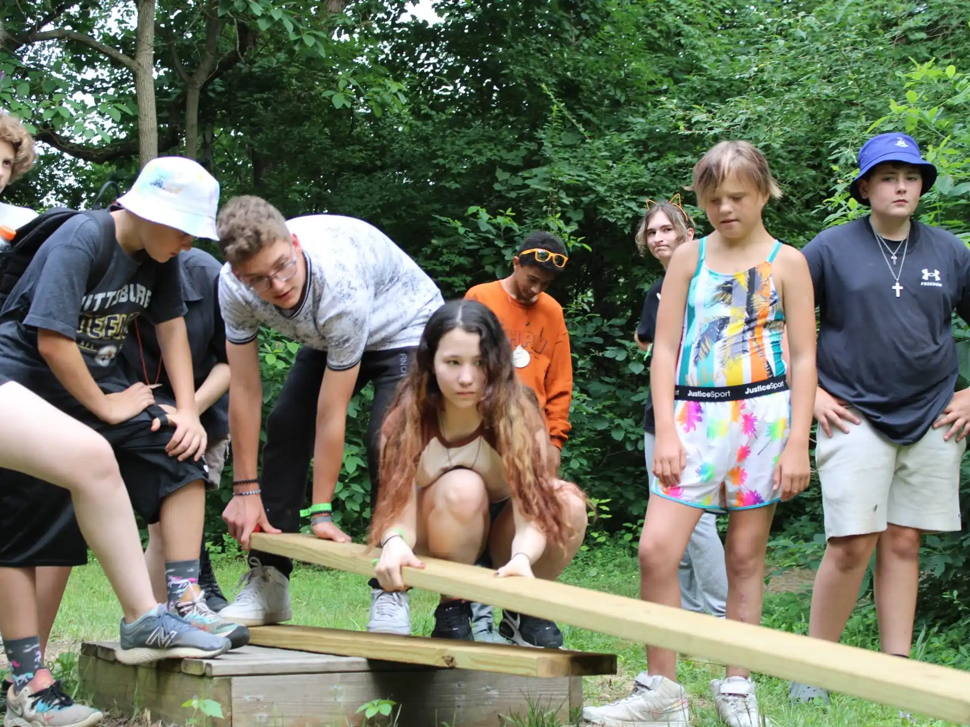 a group of people working on a wood structure
