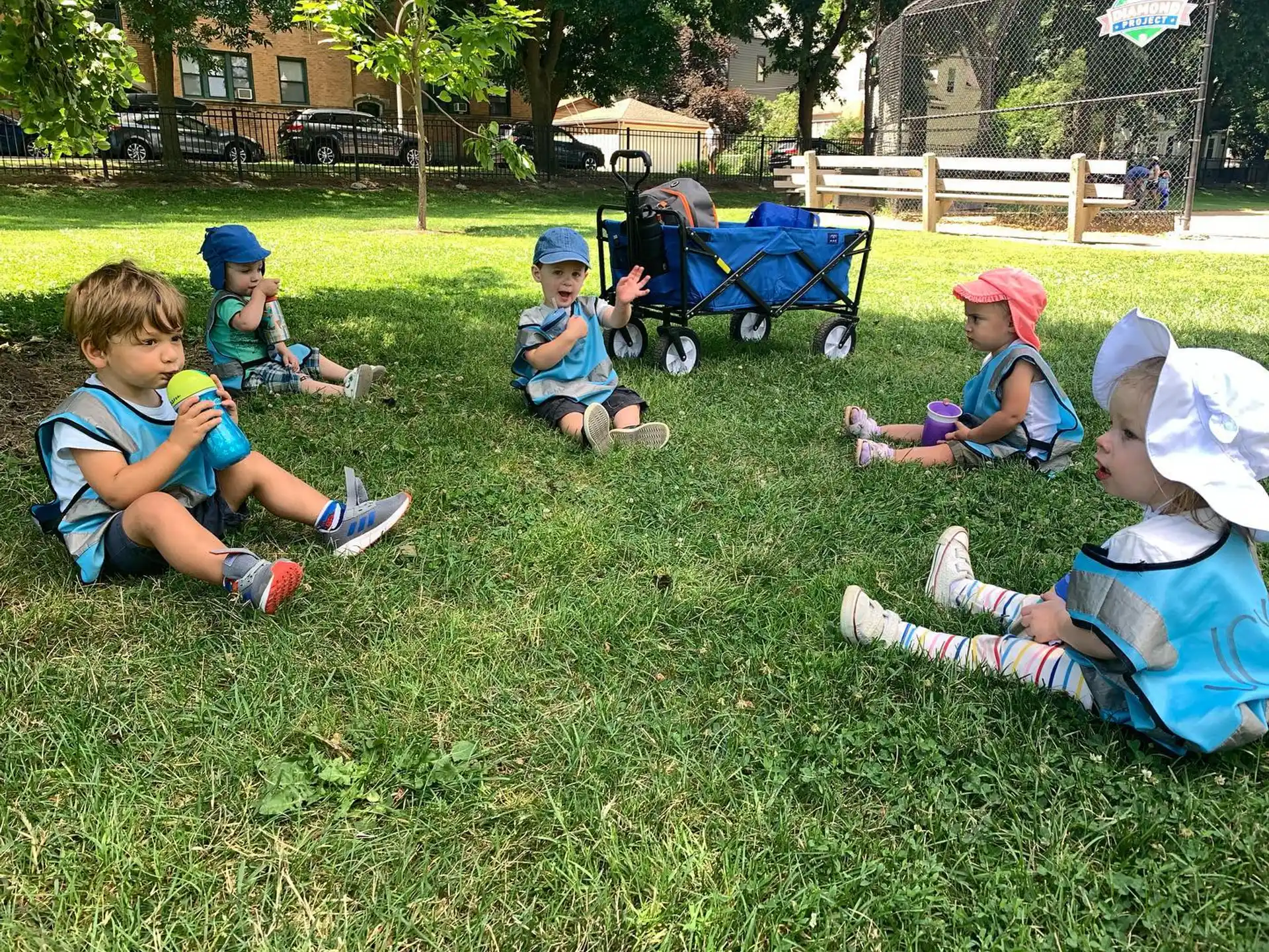 a group of kids sitting on the grass