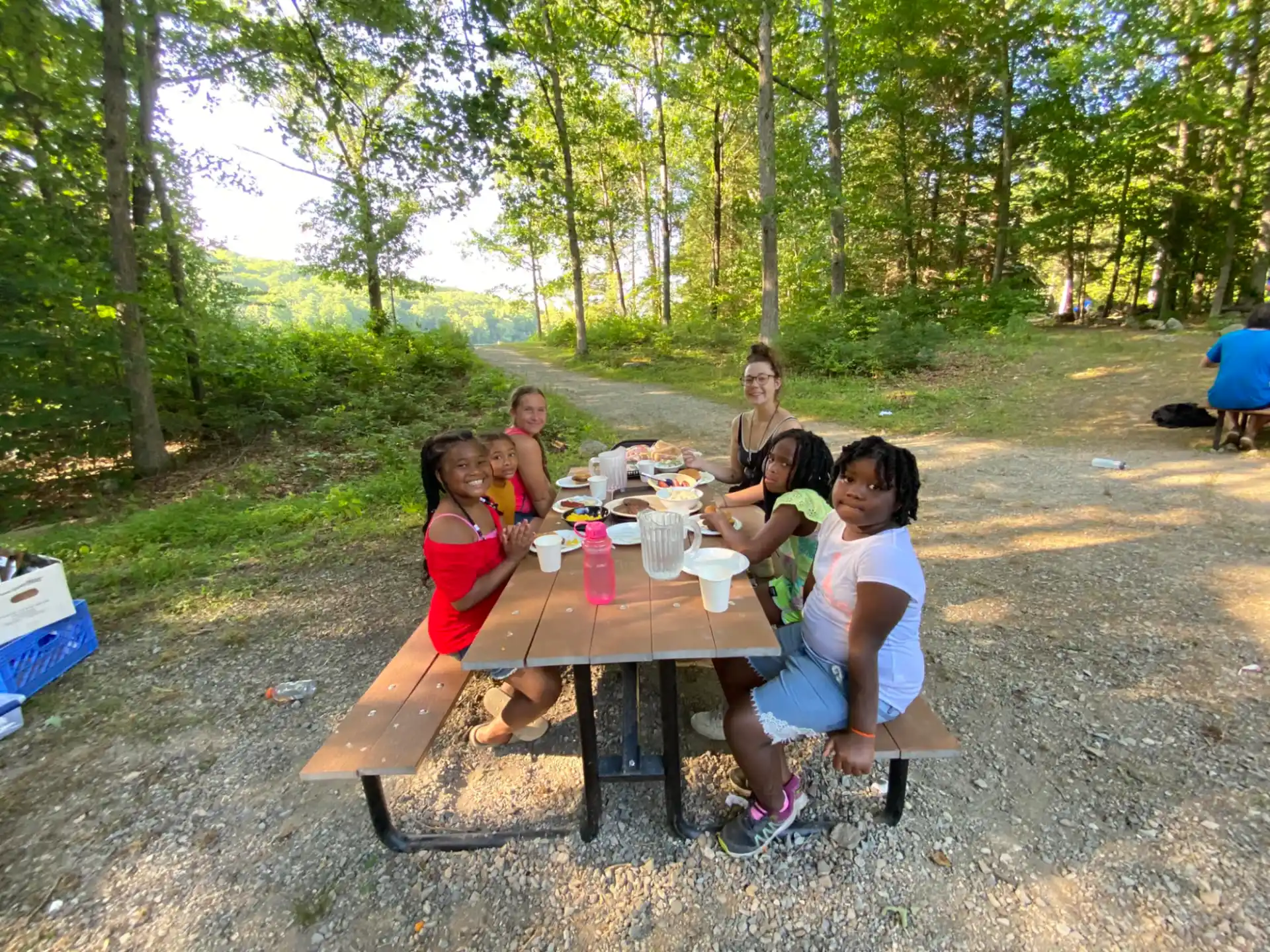 a group of people sitting around a table outside