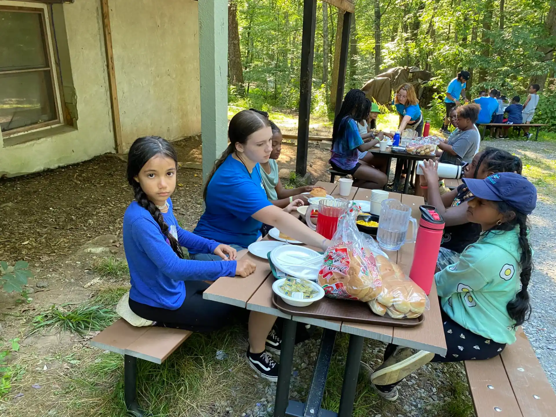 a group of people sitting at a picnic table