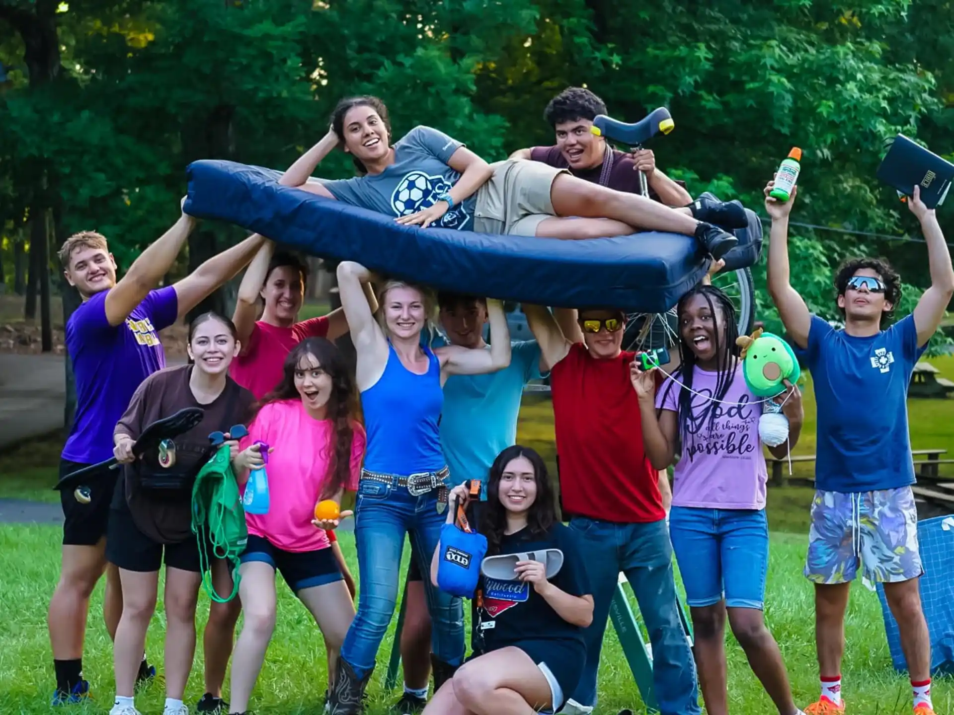 a group of people posing for a photo with a person lying on the back