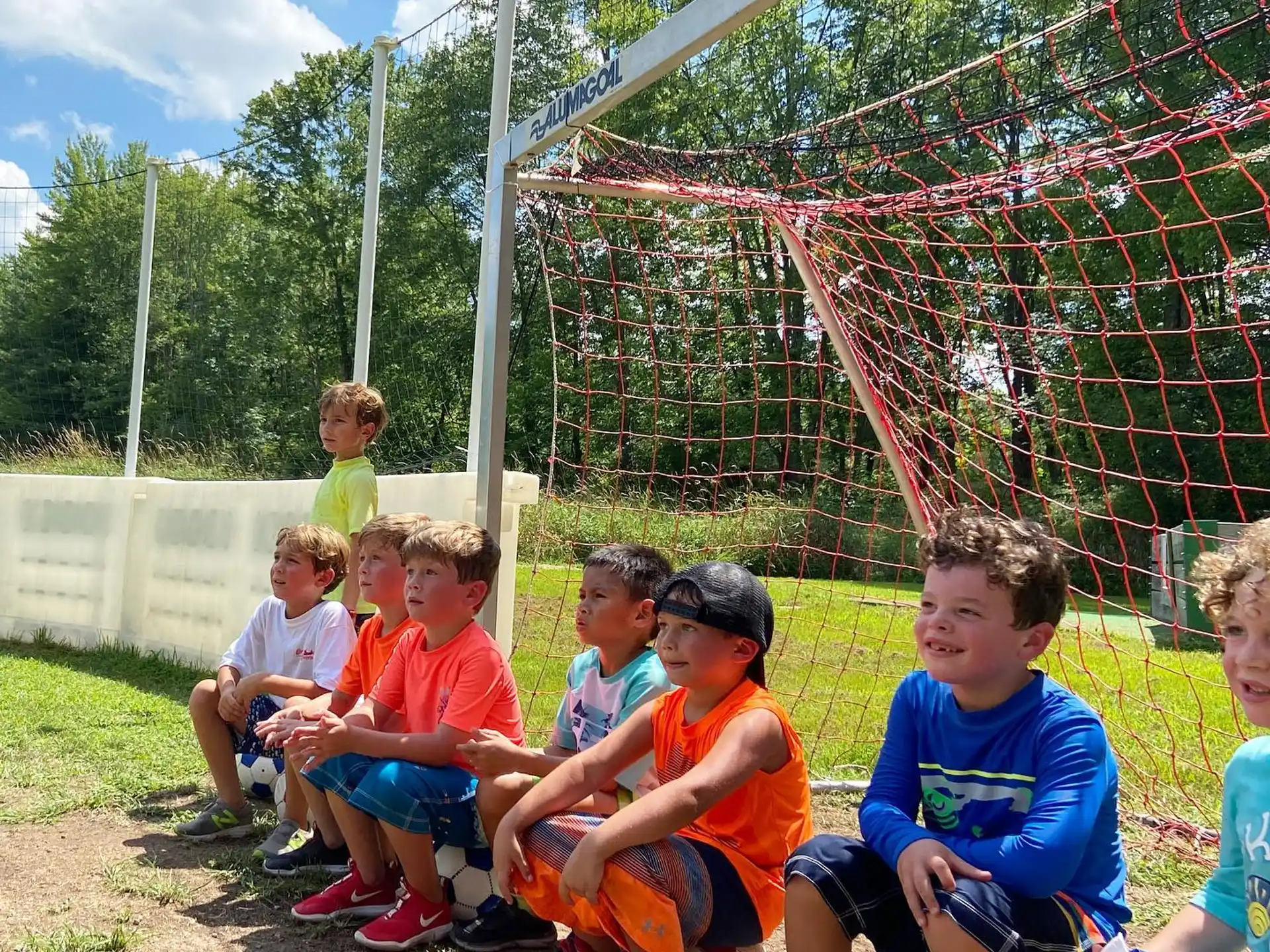 a group of kids sitting on a swing