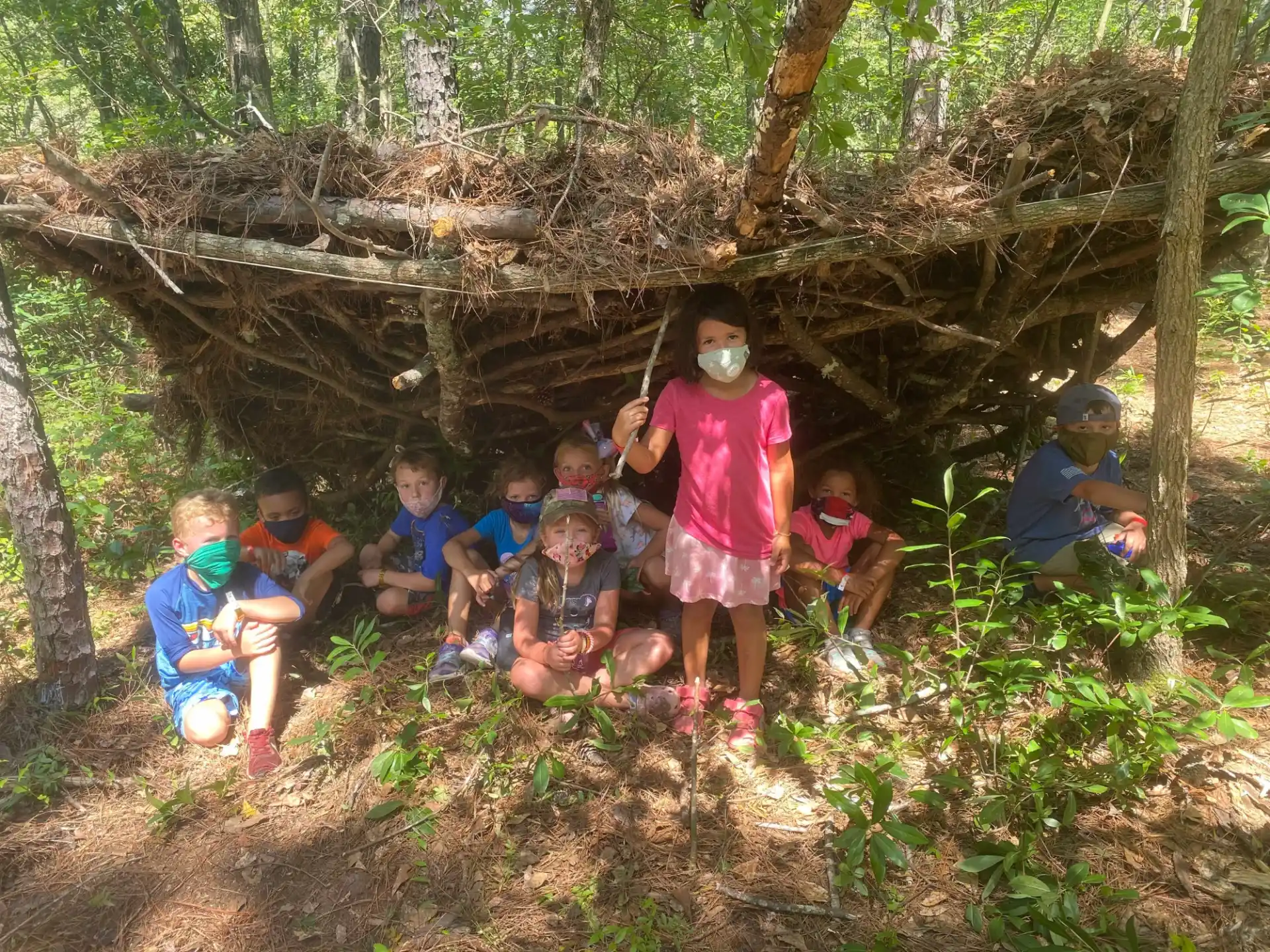 a group of kids in a wooded area