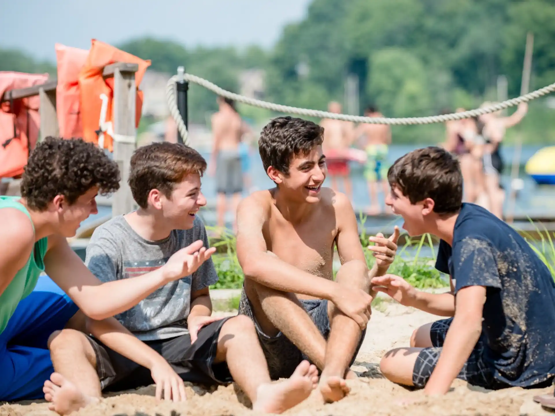 a group of men sitting on the beach