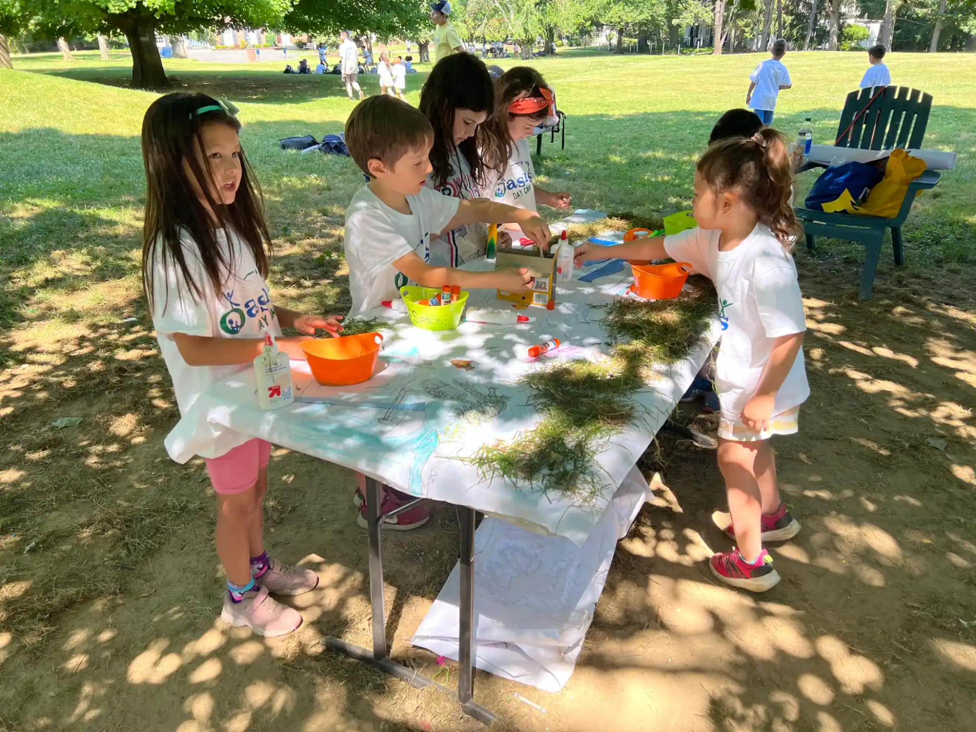 a group of children playing with a table outside