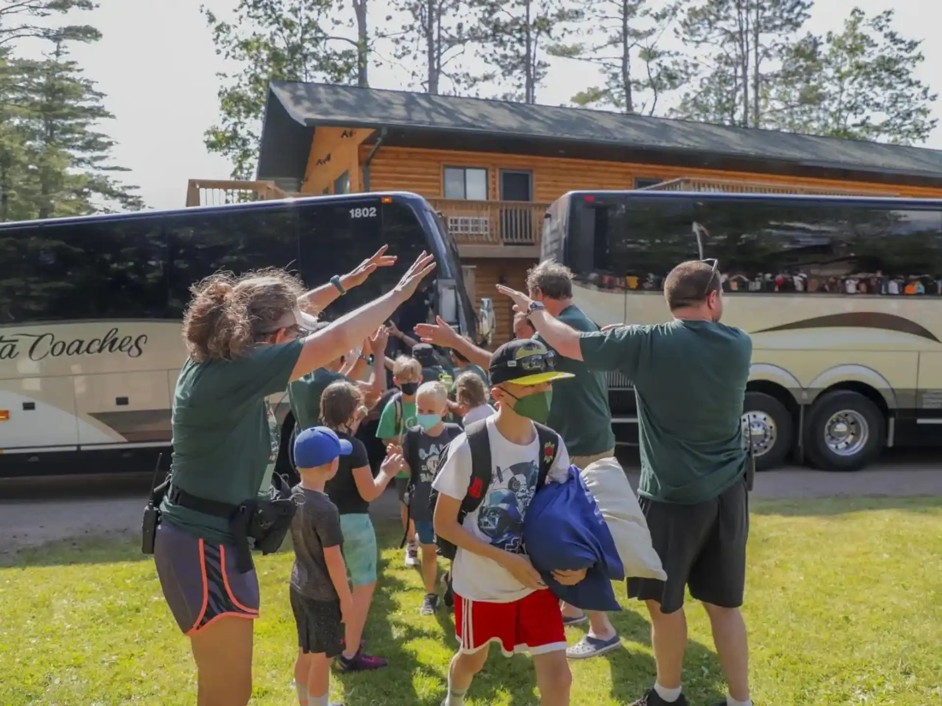 a group of people standing in front of a bus