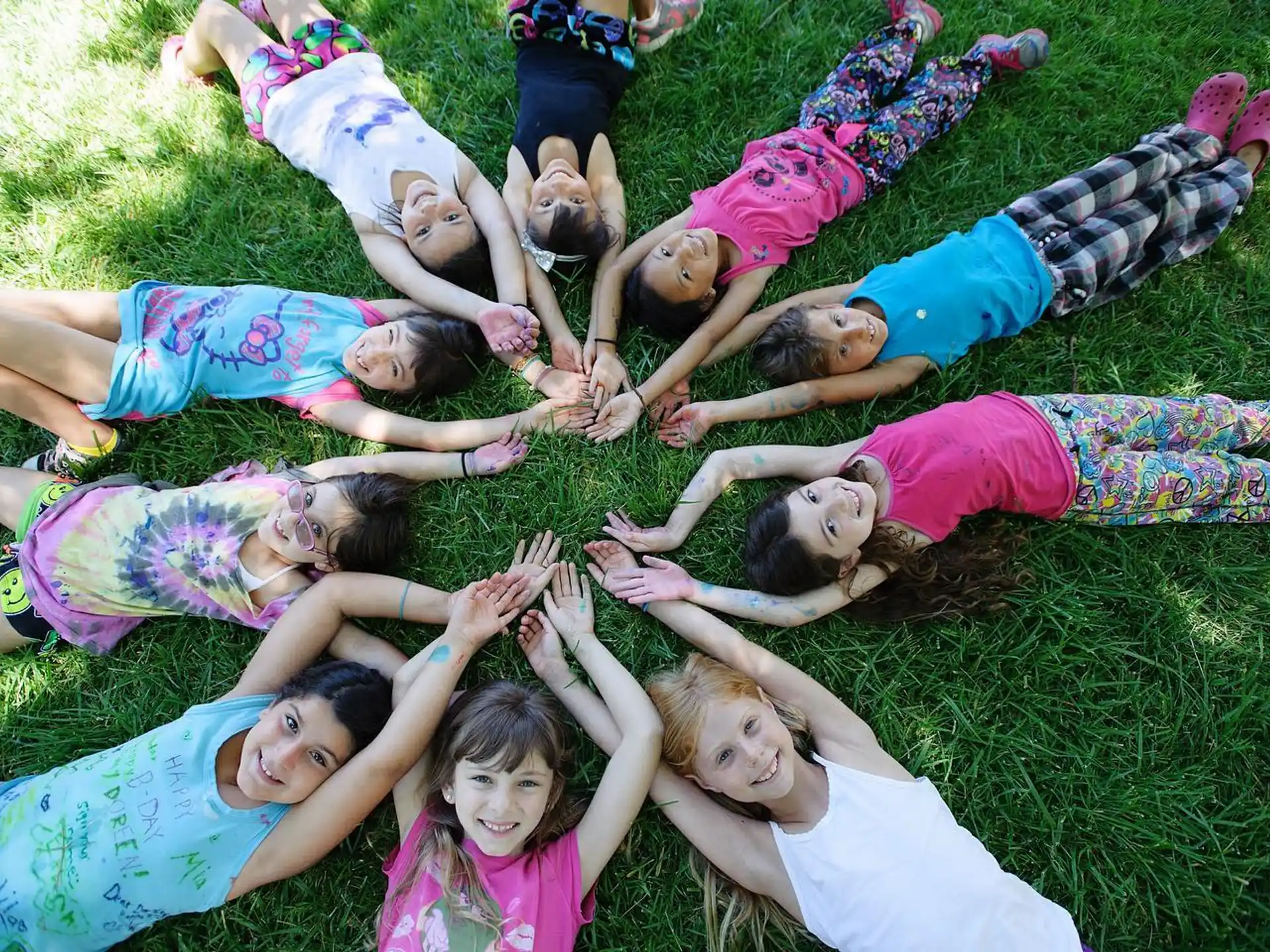 a group of children playing in the grass