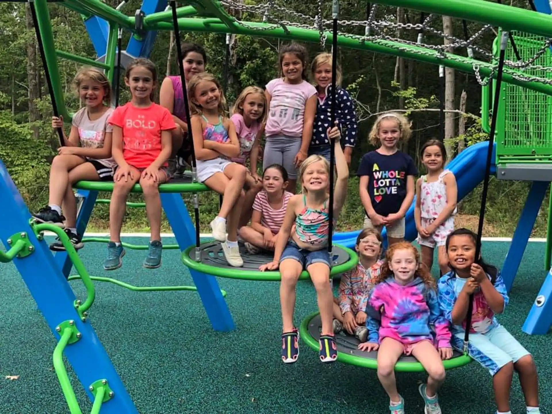 a group of children posing for a photo on a playground