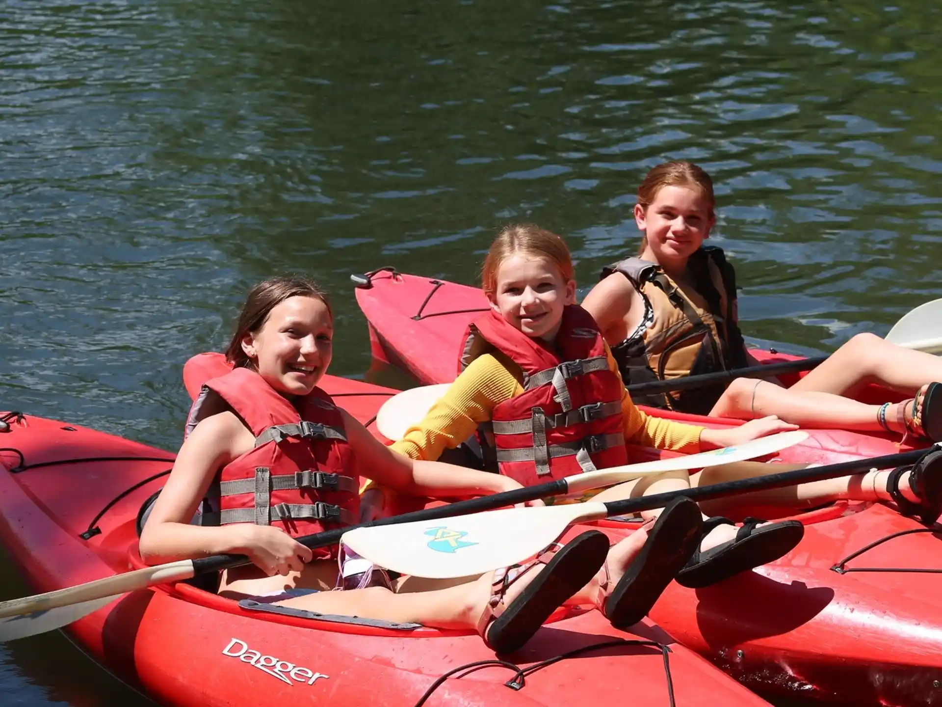 a group of people in a red canoe on water