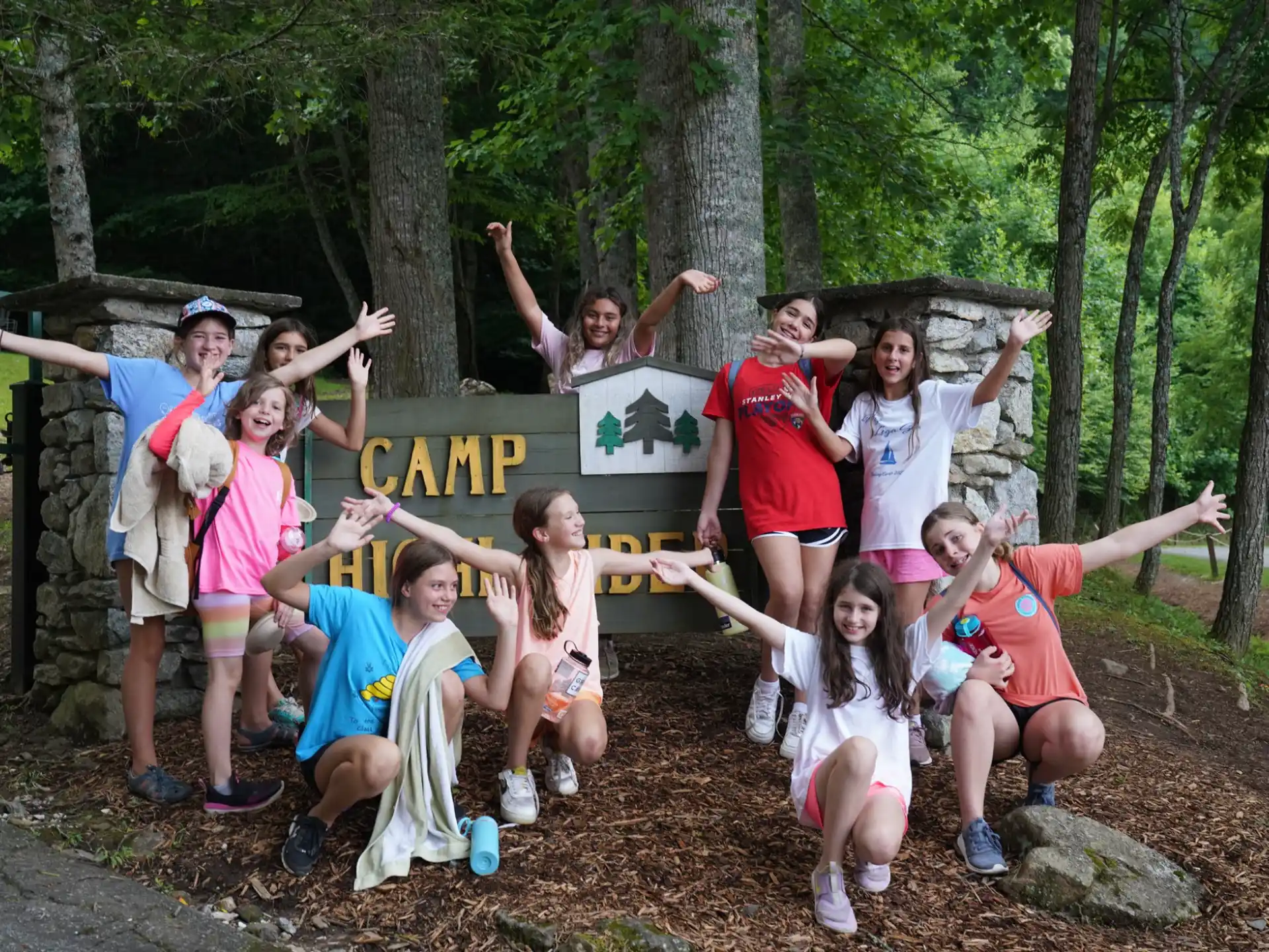 a group of people posing for a photo in front of a sign