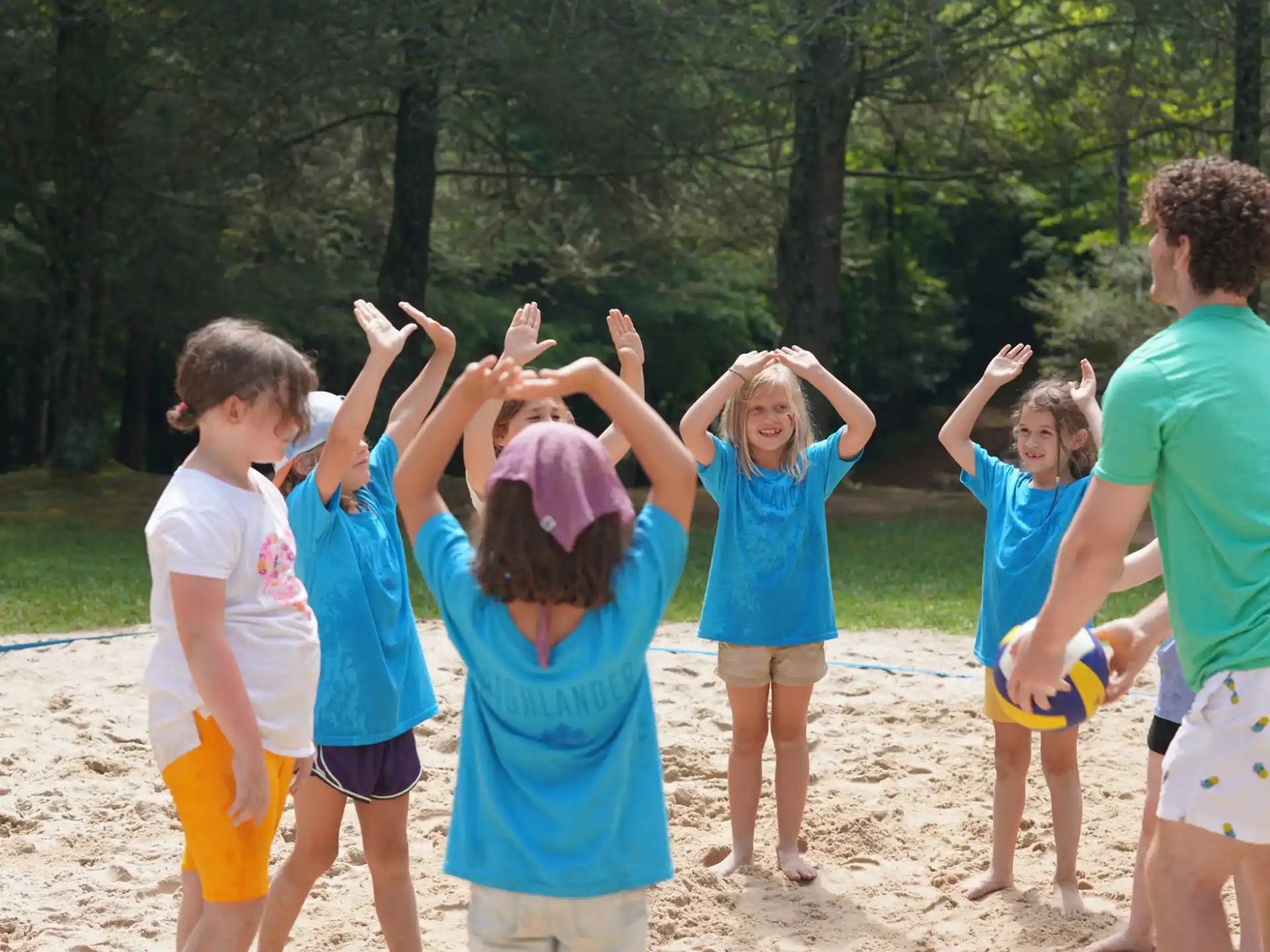 a group of people standing on a beach