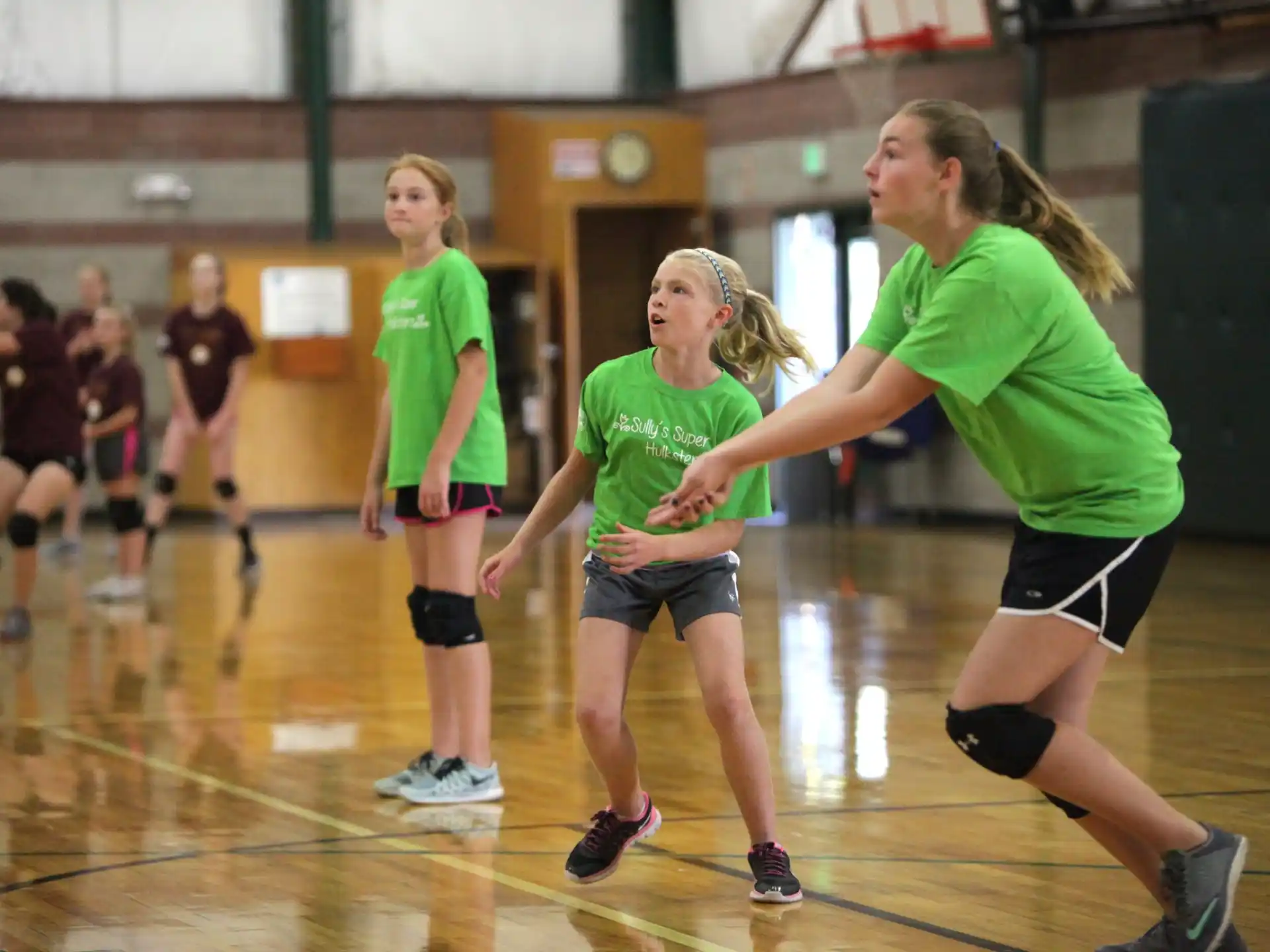 a group of women playing volleyball
