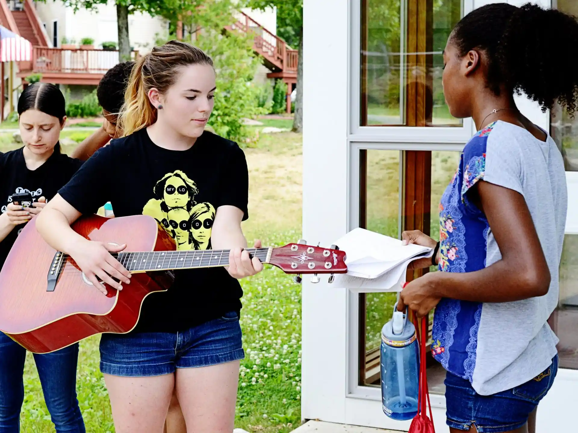 a group of girls playing a guitar