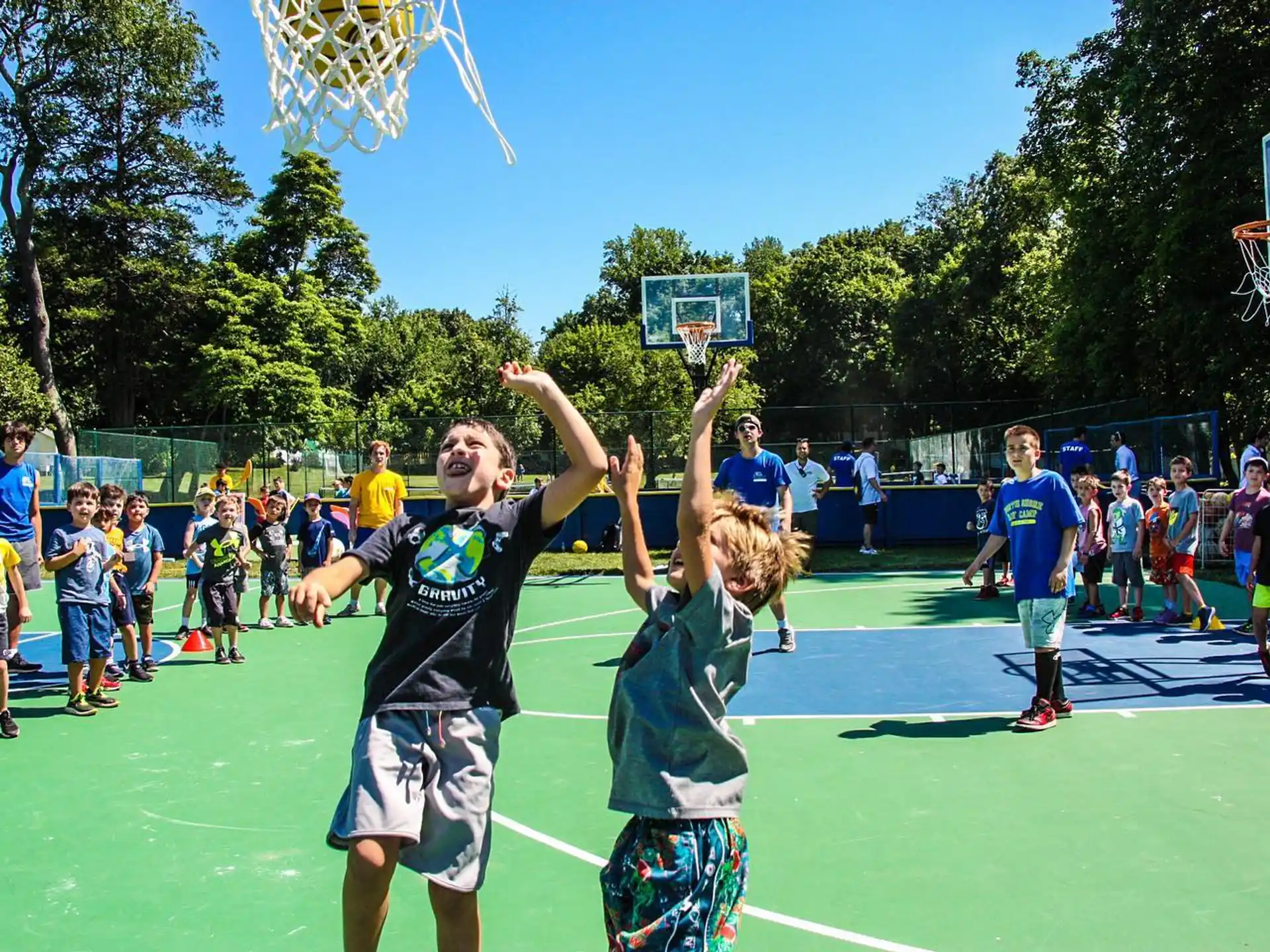 a group of people playing basketball