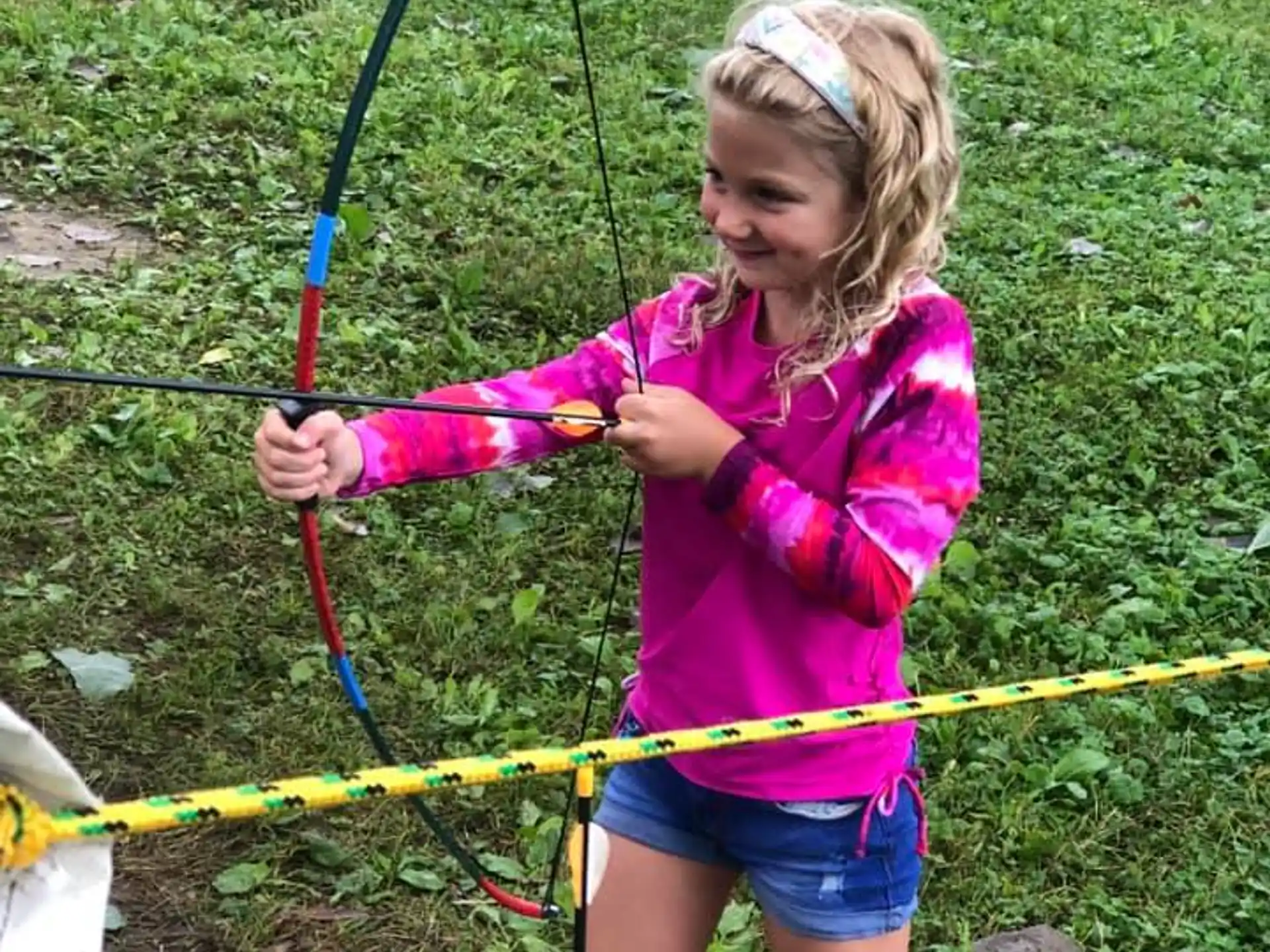 a girl holding a bow and arrow
