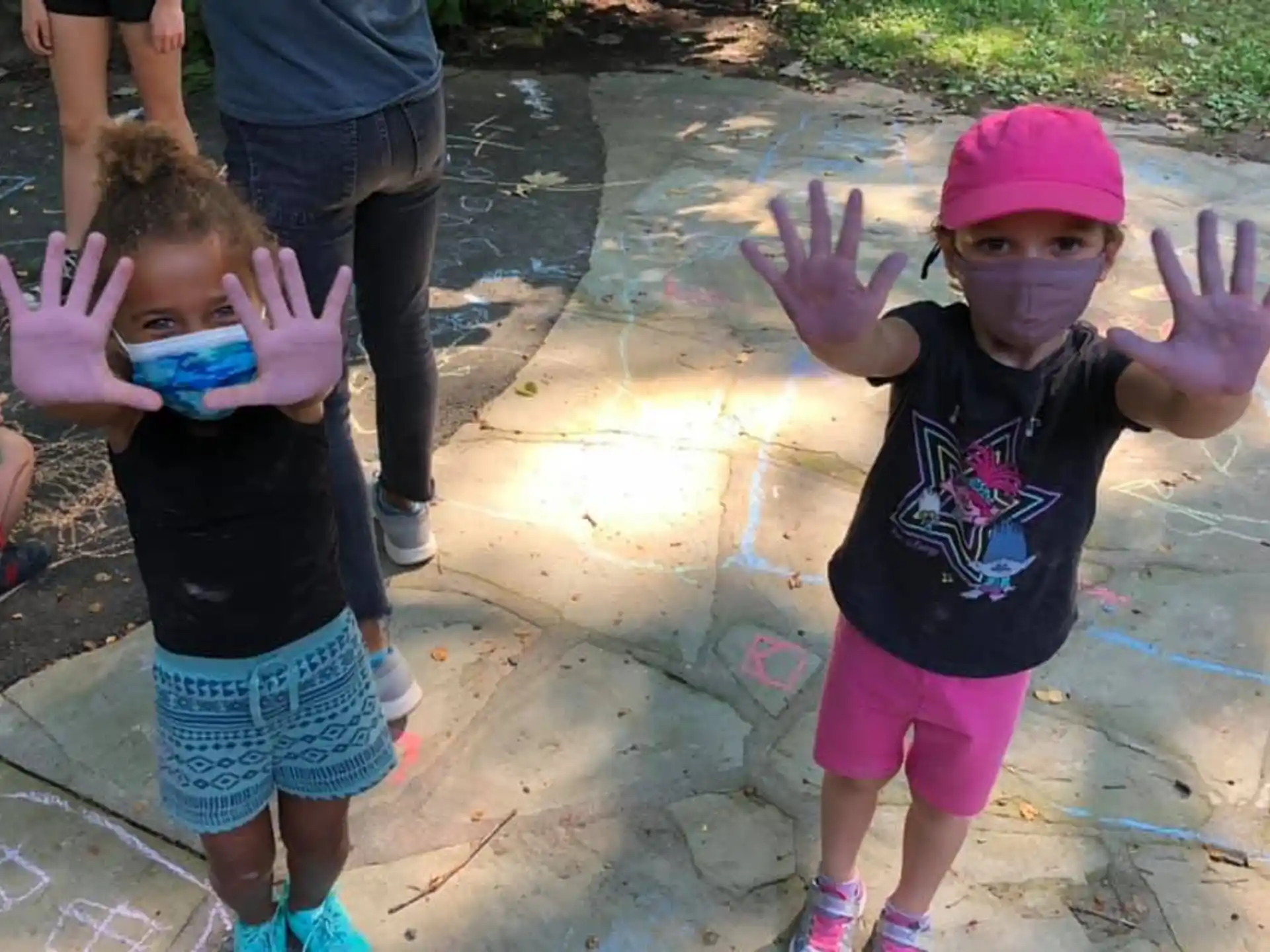a group of children with their hands up
