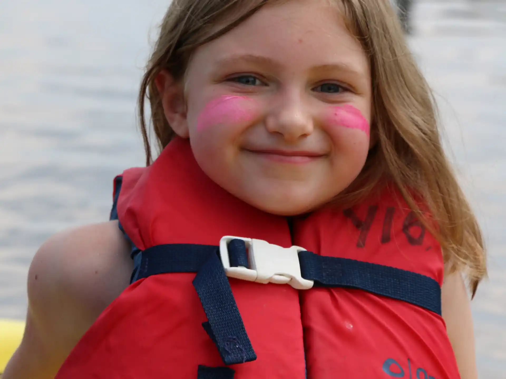 a girl wearing a life jacket