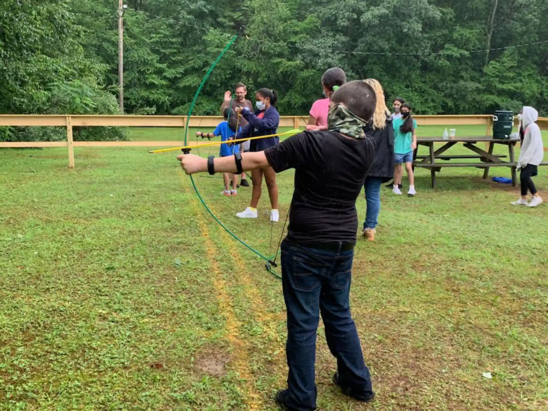 a group of people playing with bows and arrows