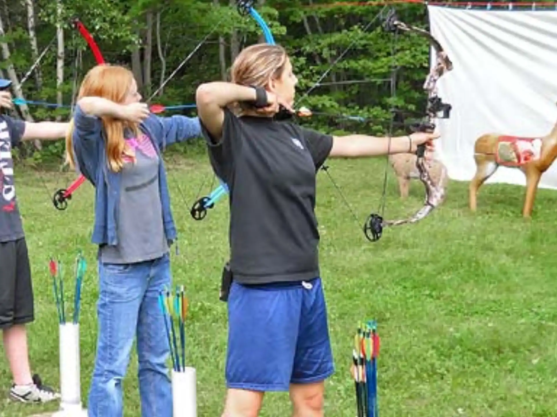 a group of people shooting bows