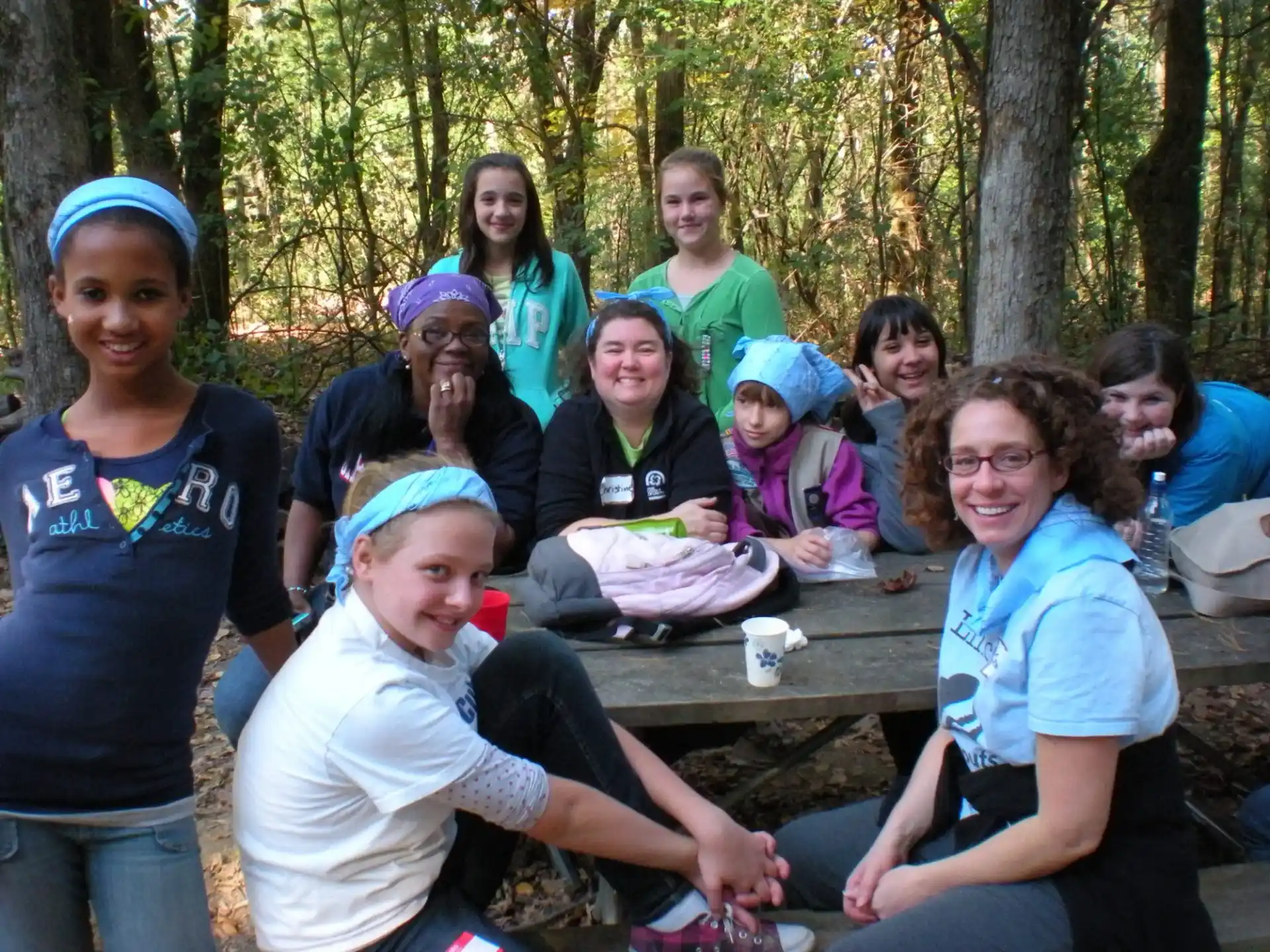 a group of people sitting at a picnic table