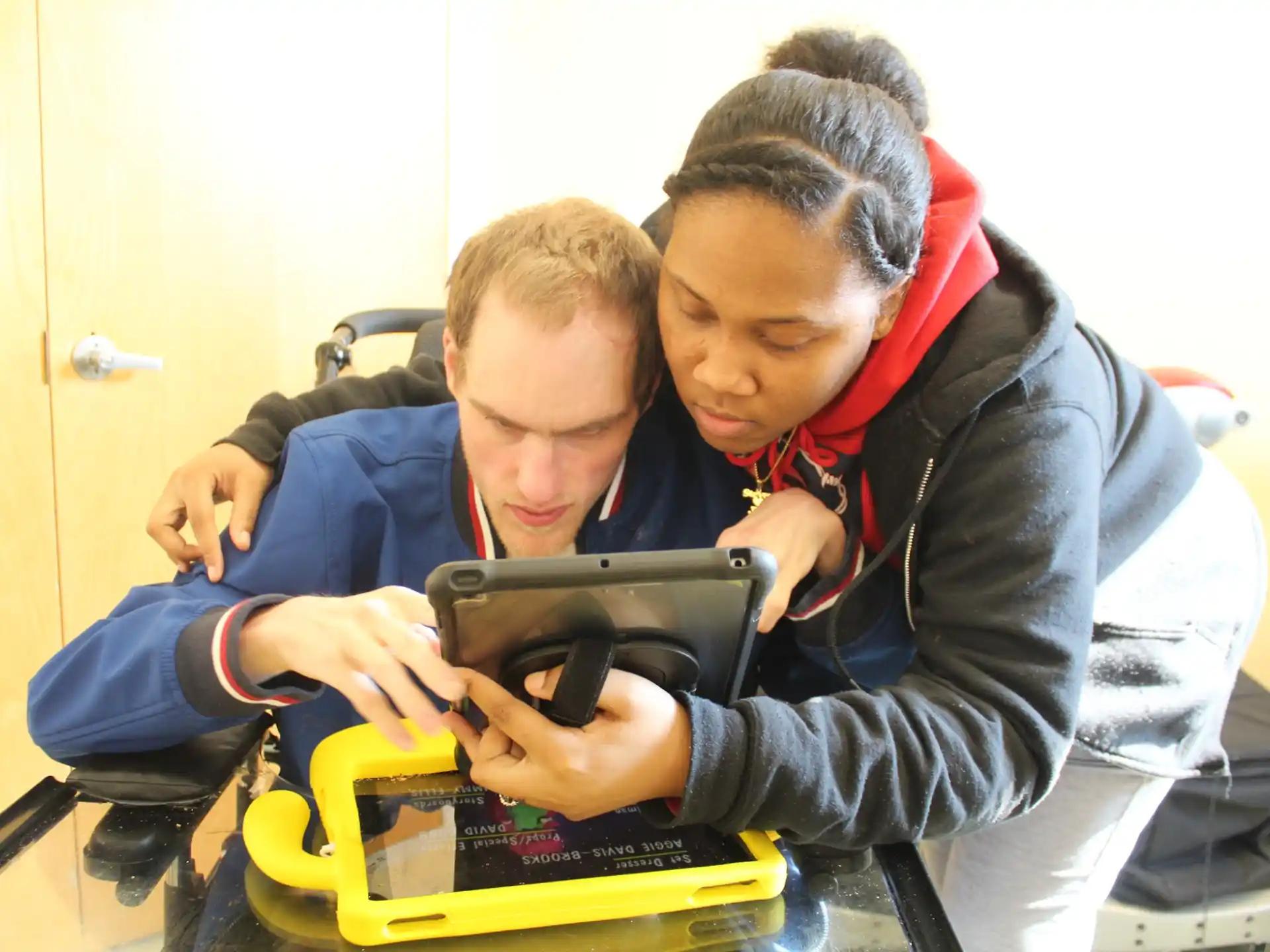 a man and a boy looking at a tablet