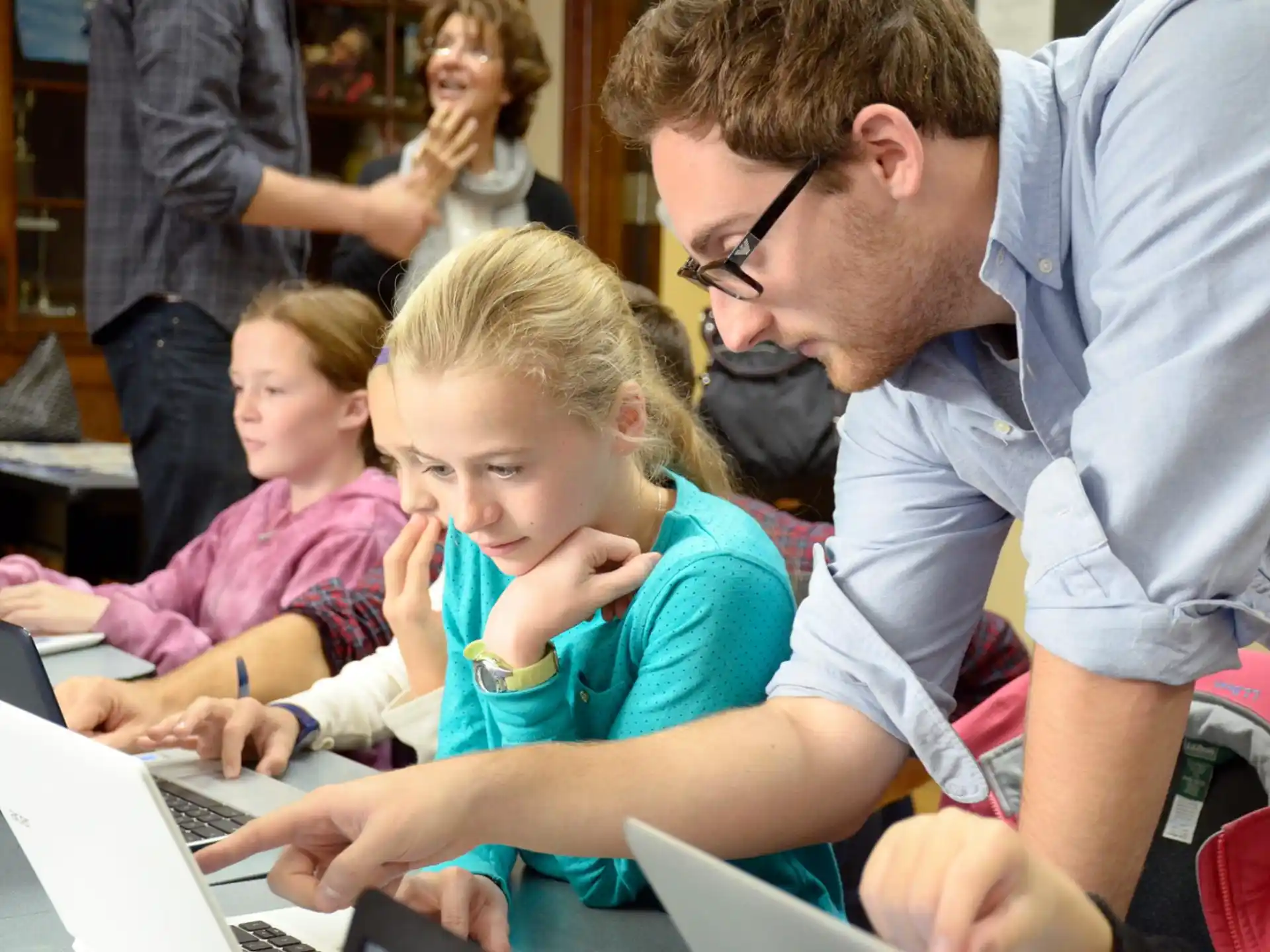 a person and a child using a laptop