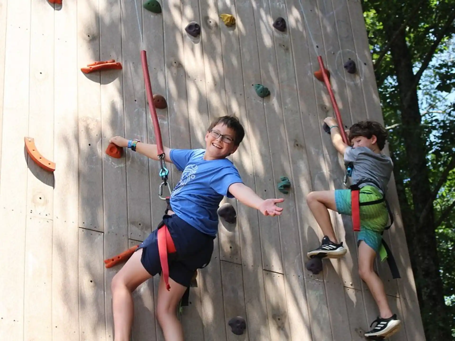 a man and a boy climbing a rock wall