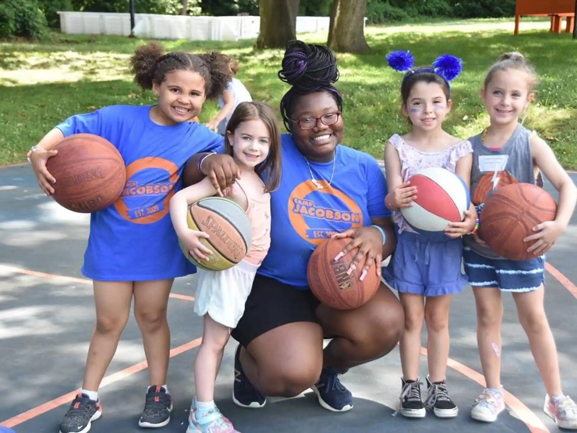 a group of kids holding basketballs