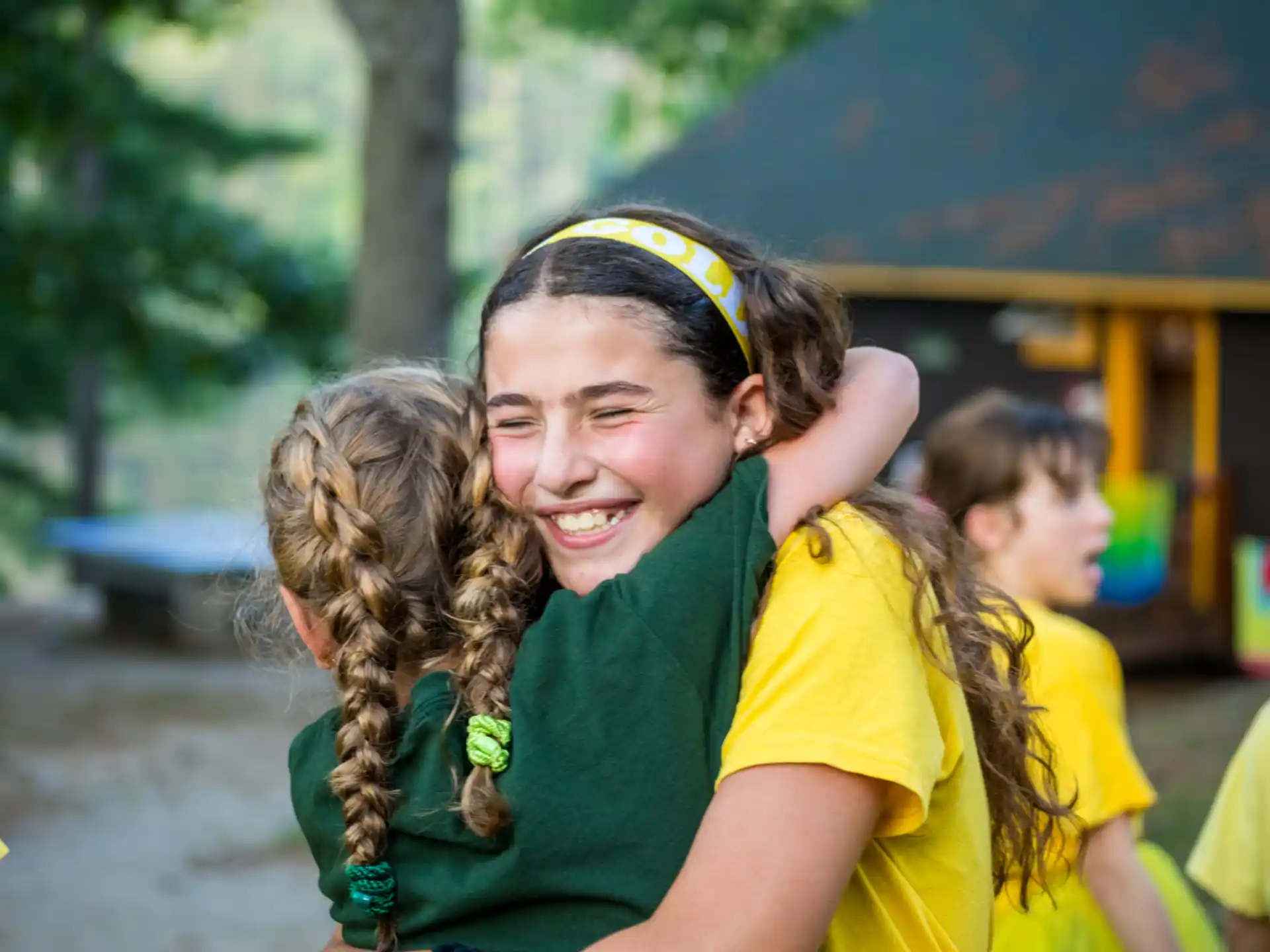 a person with the hair in a ponytail smiling