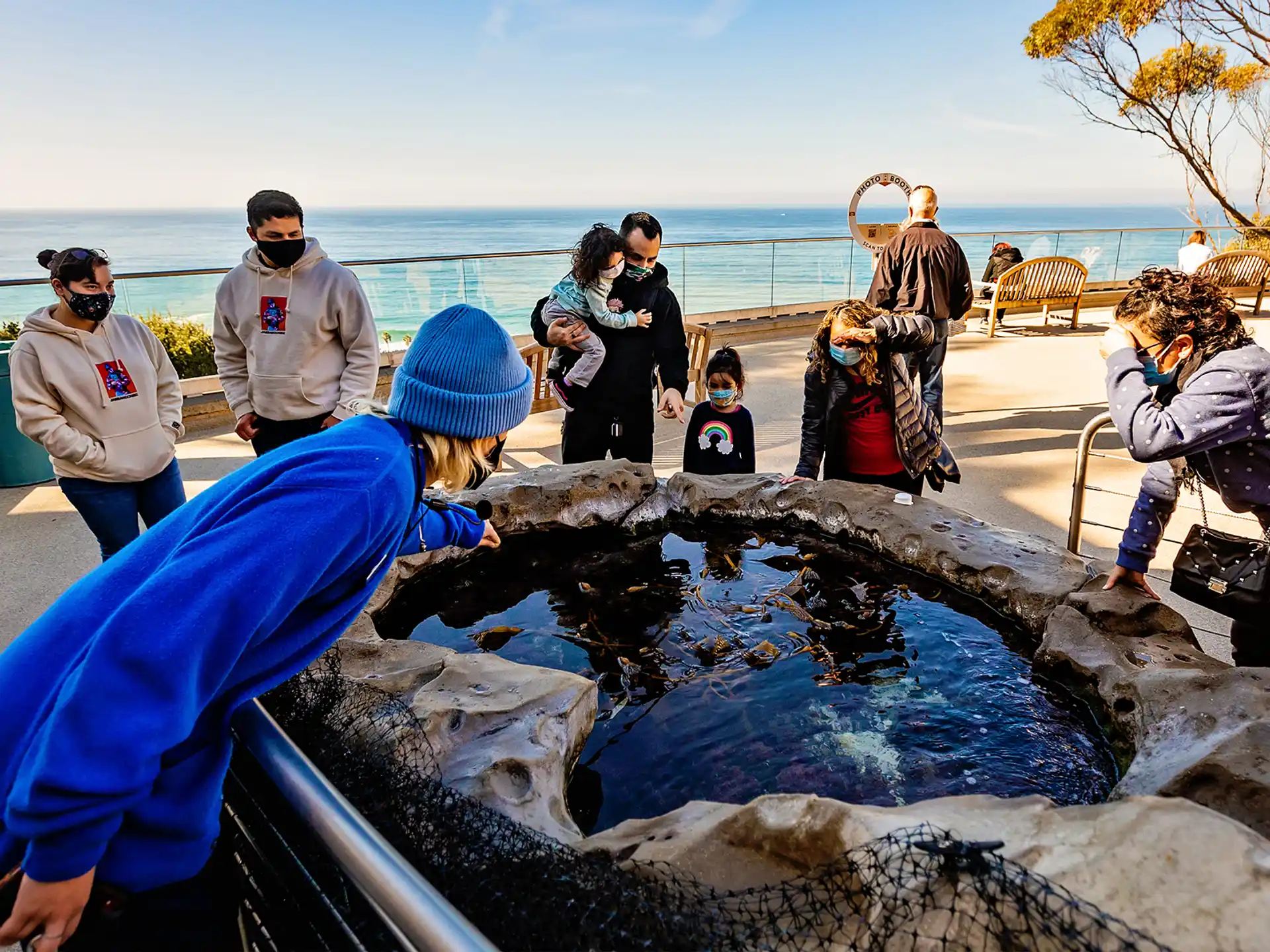 a group of people around a fire pit