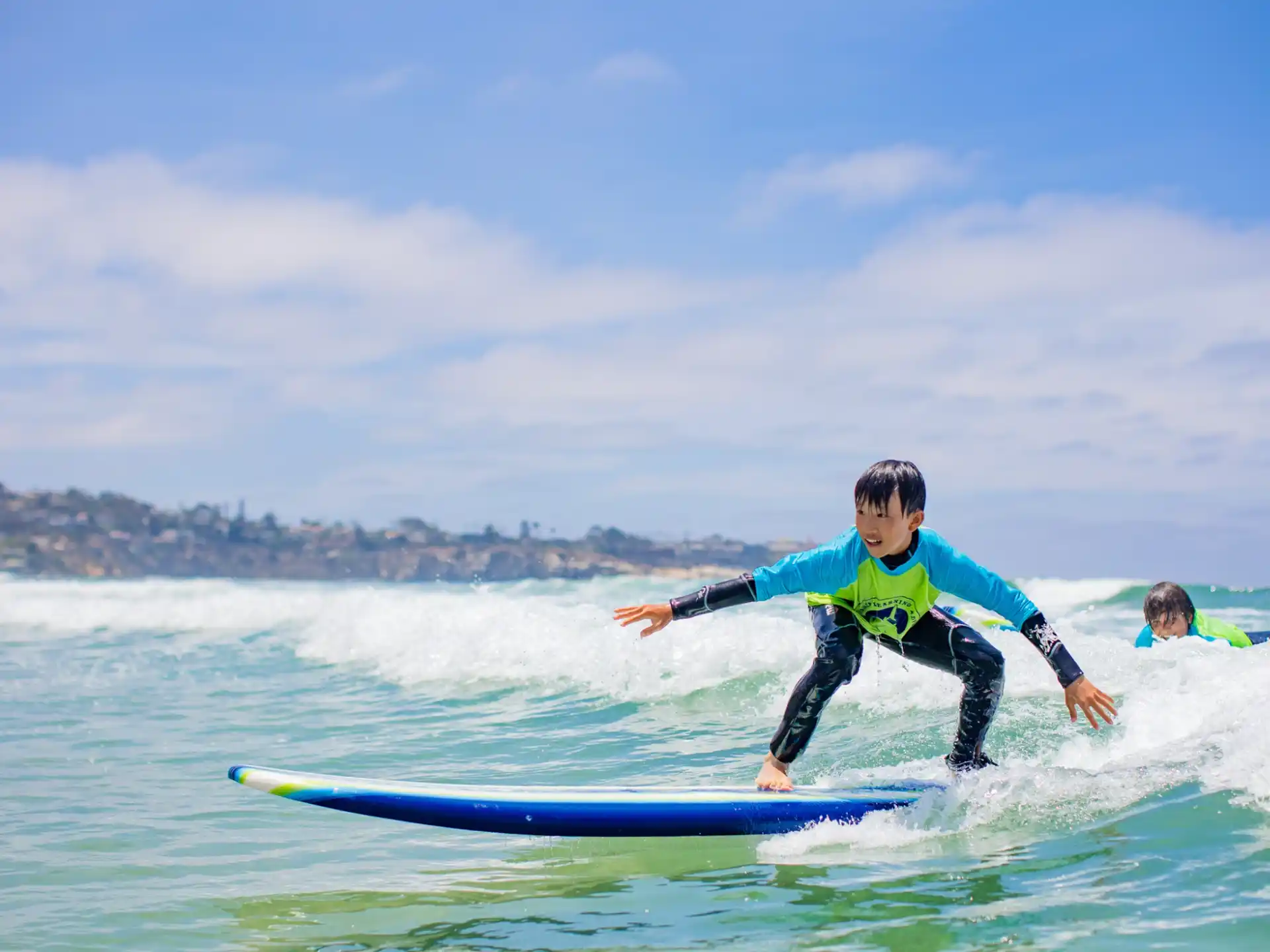 a kid surfing on the waves