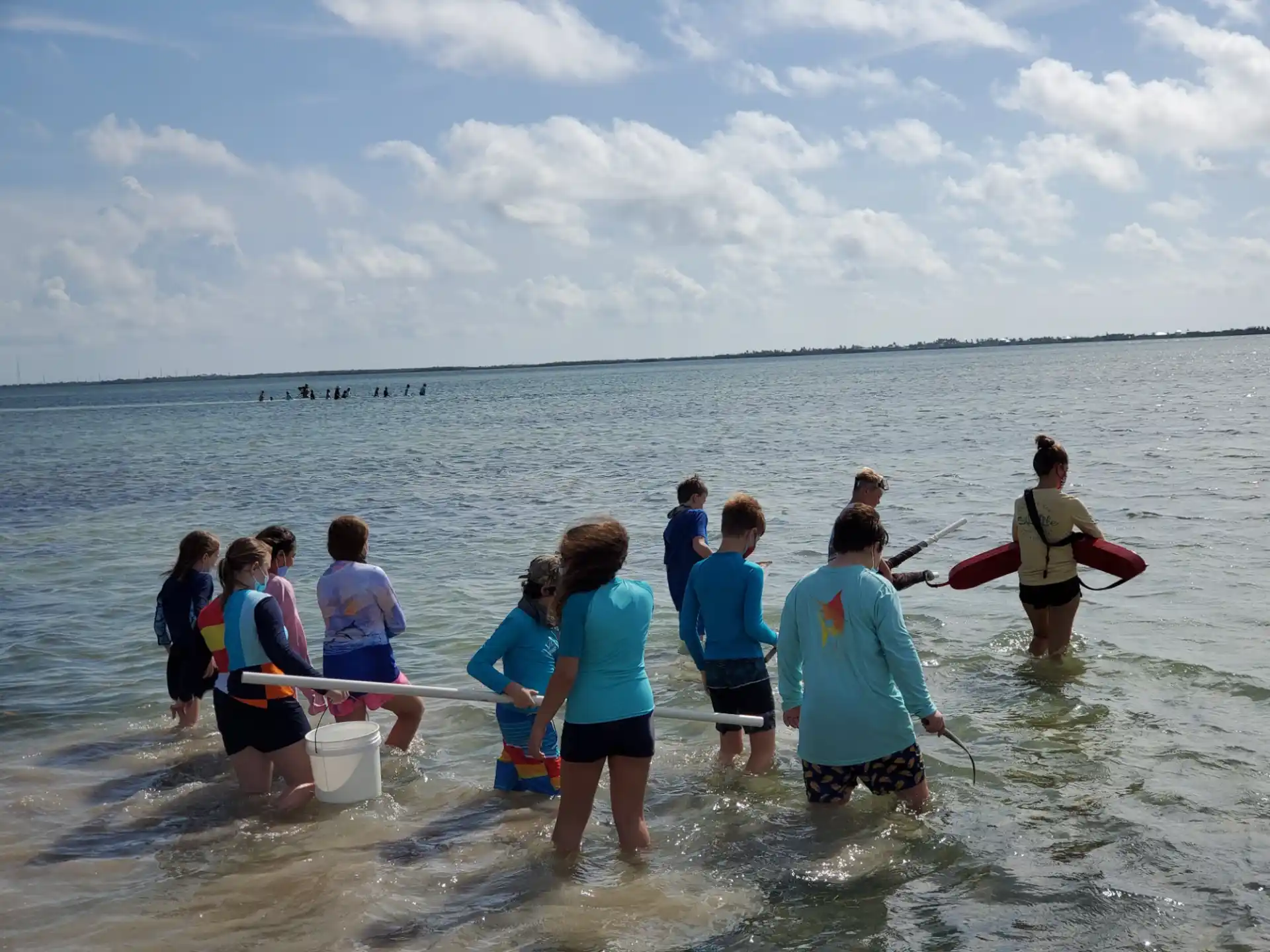 a group of people standing in water