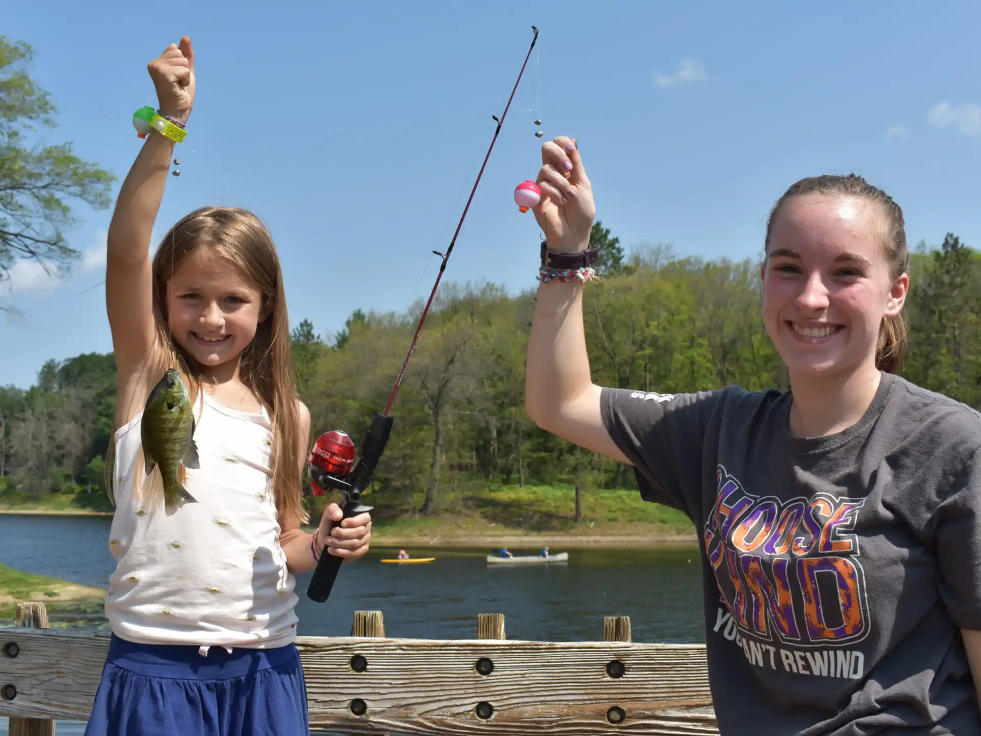 a man and a woman holding a fishing pole
