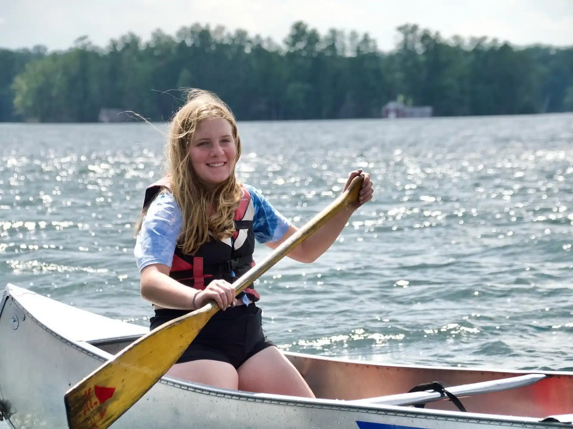 a person in a boat holding a fish