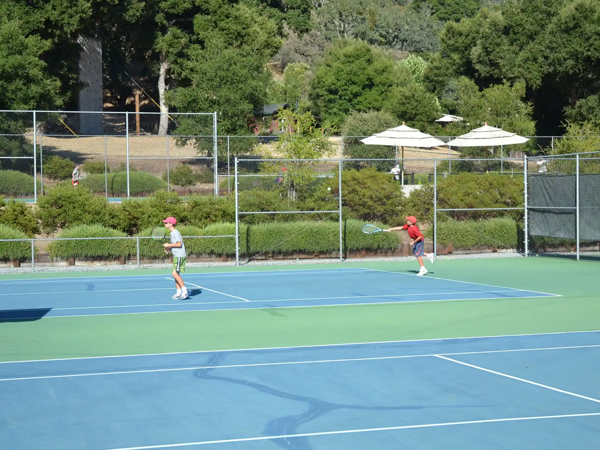 a couple of people play tennis
