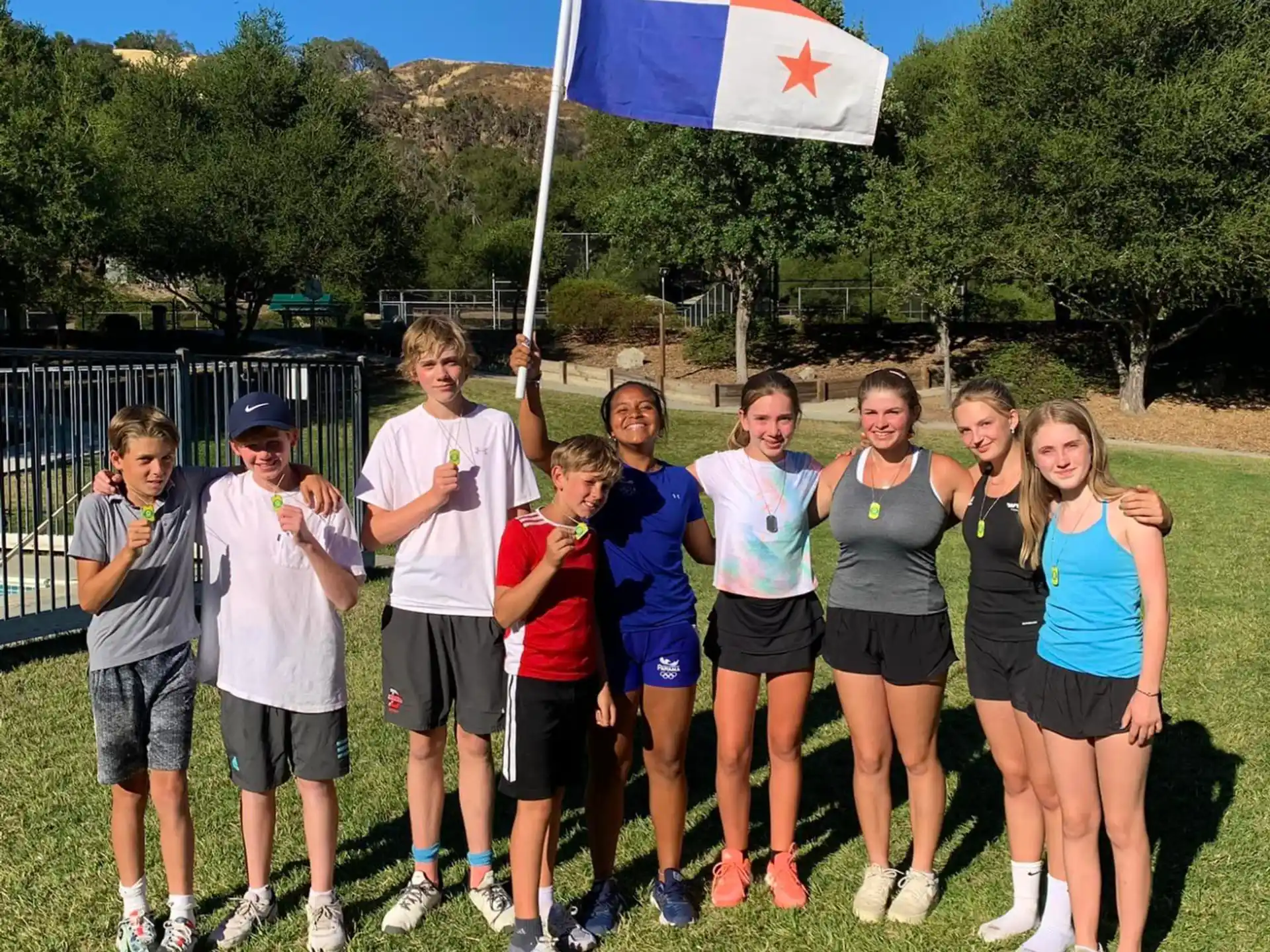a group of people posing for a photo with a flag