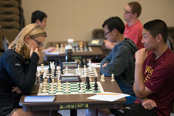 a group of people playing chess