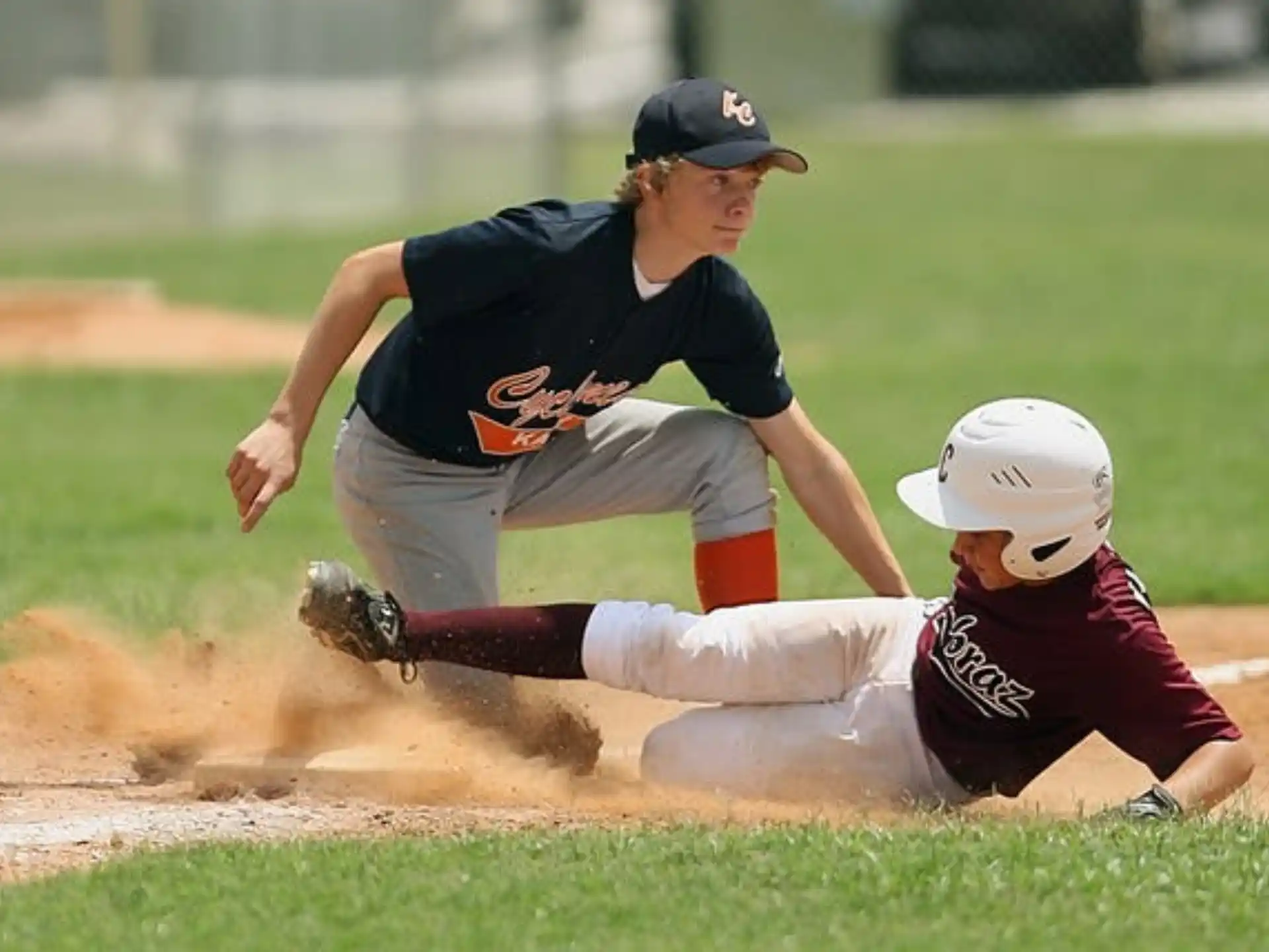 a baseball player sliding into second base