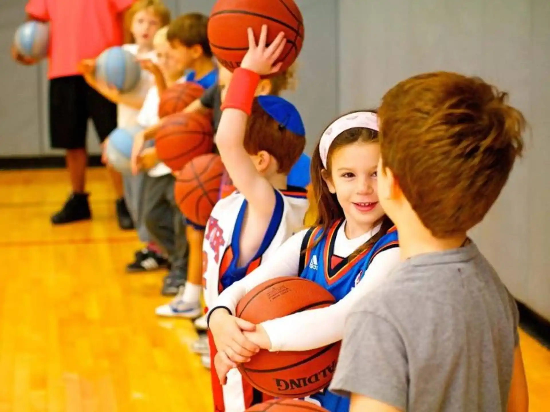 a group of kids playing basketball