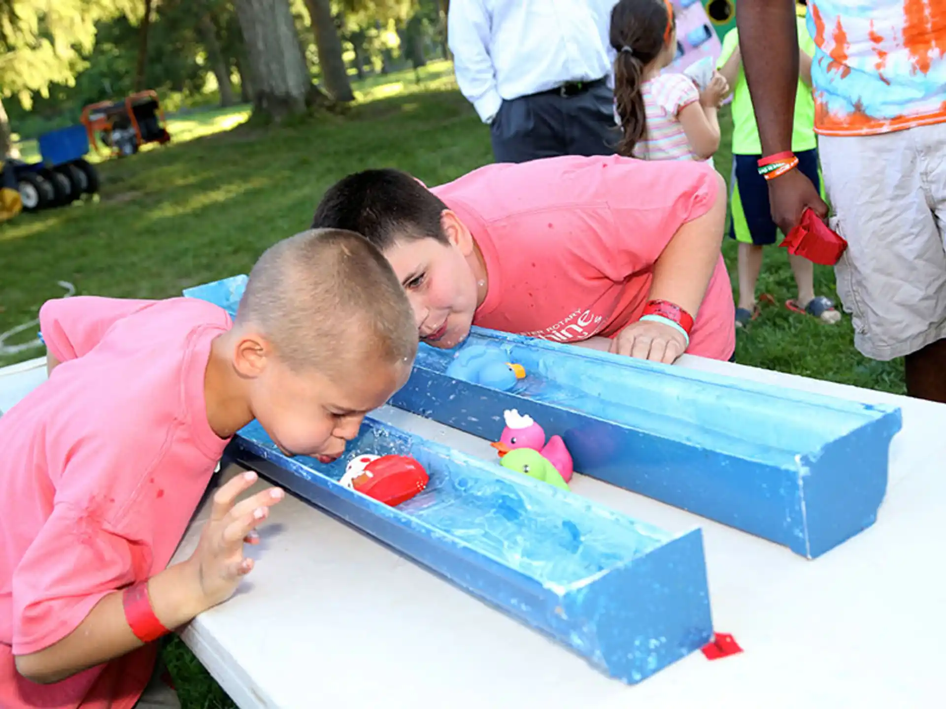 a couple of boys playing with a toy on a table