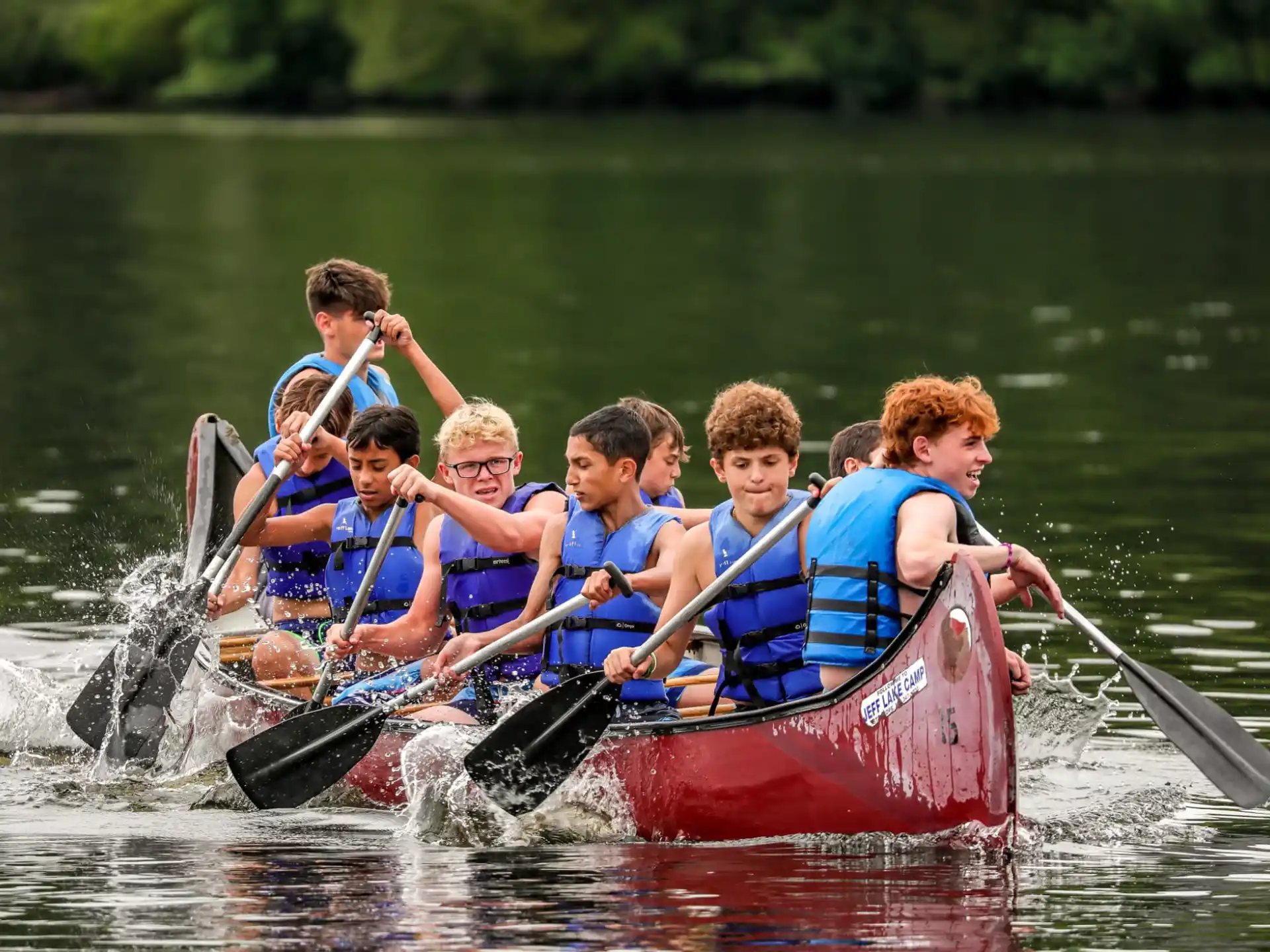 a group of people rowing a boat